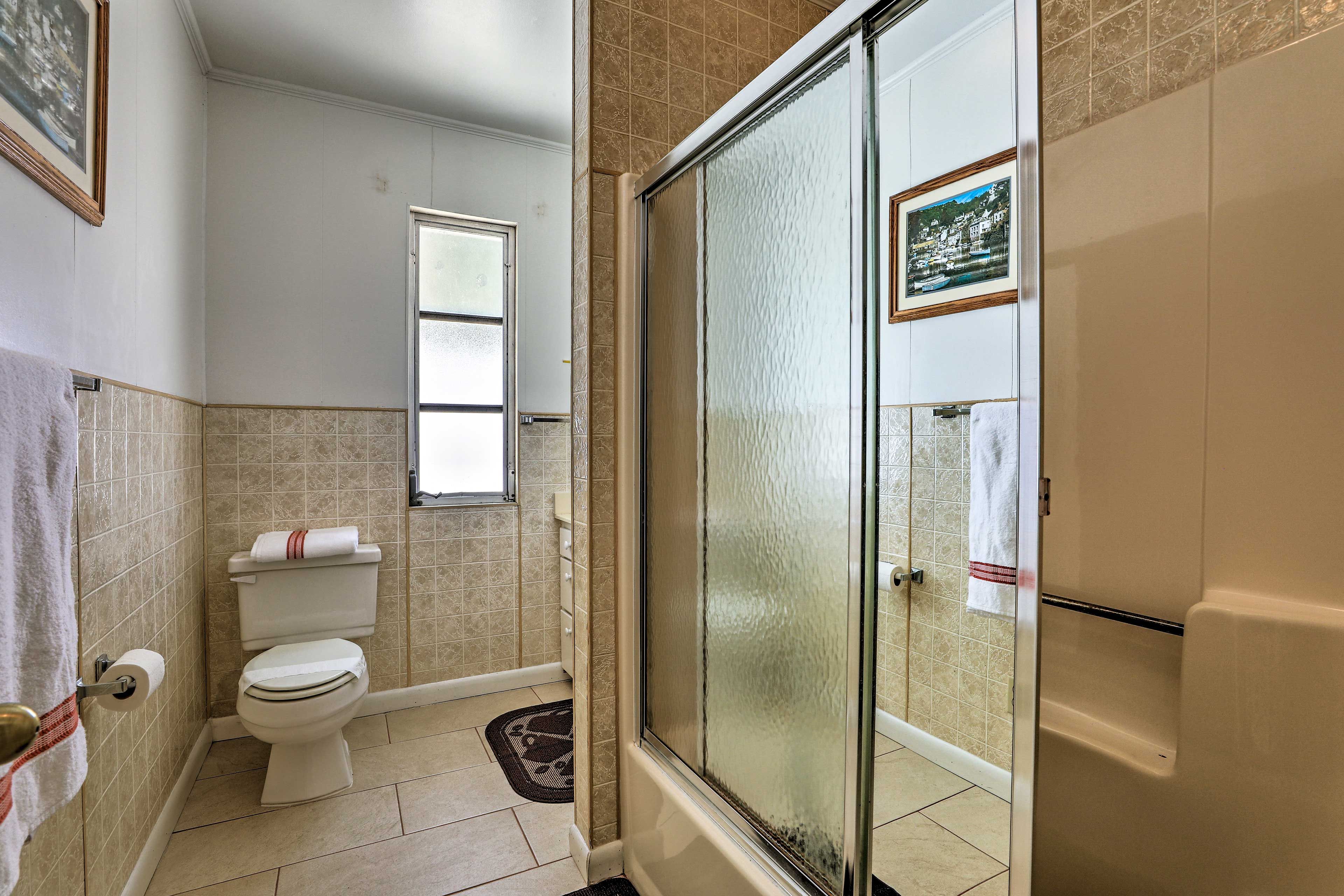 The first bathroom has a shower/tub combo.