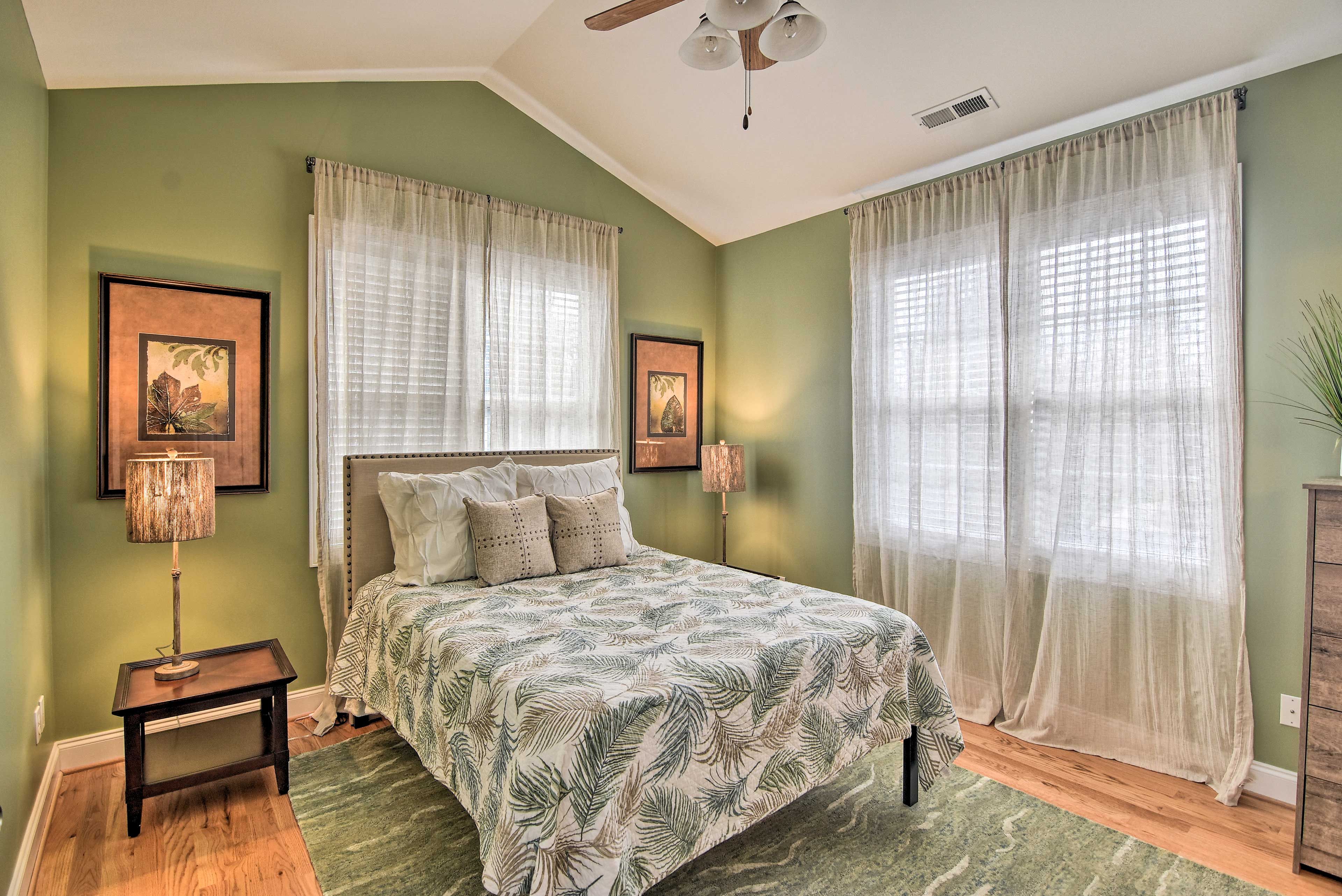 The primary bedroom has zen vibes and a queen-sized bed.