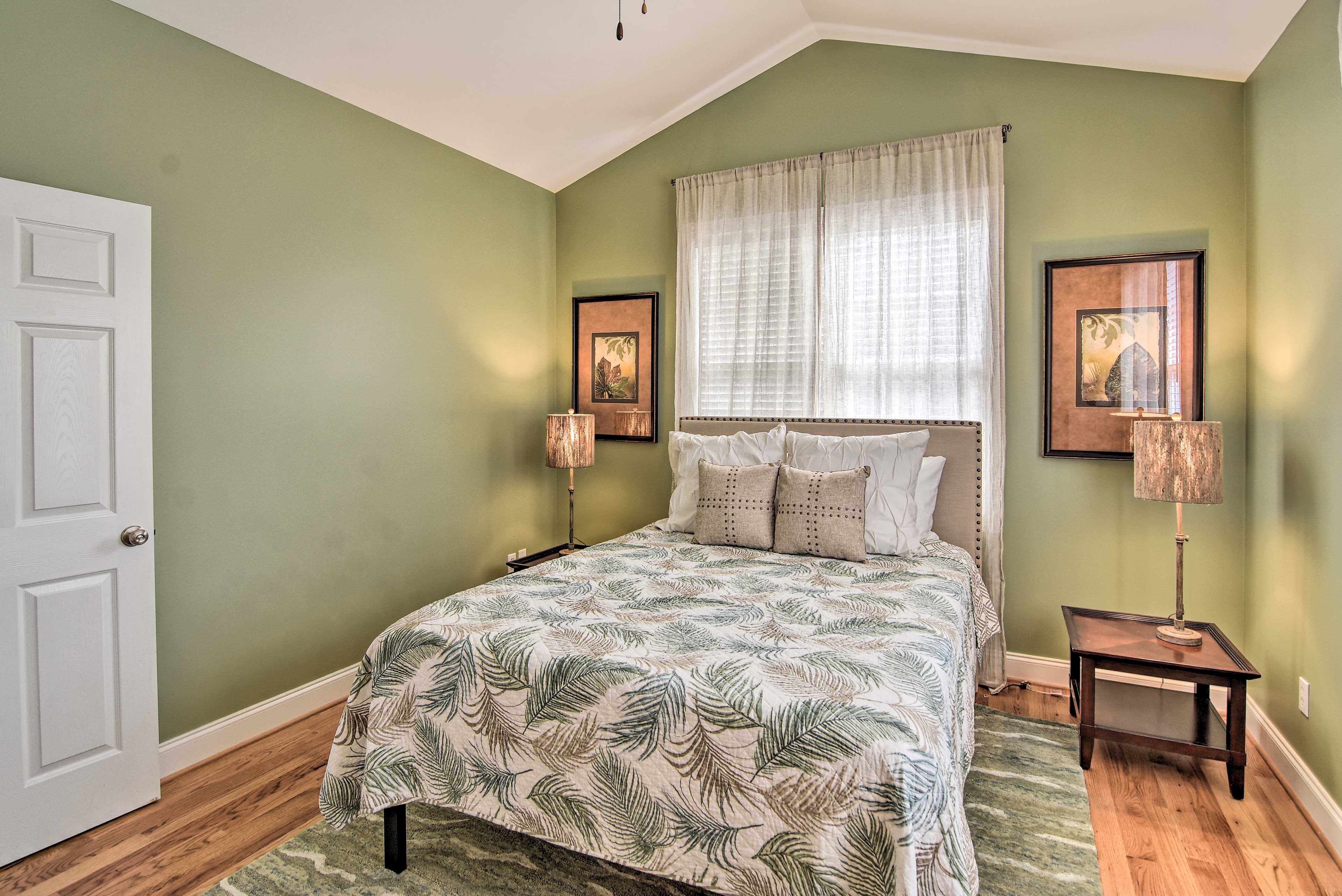 Open the window and read a book on the forest-green bed.