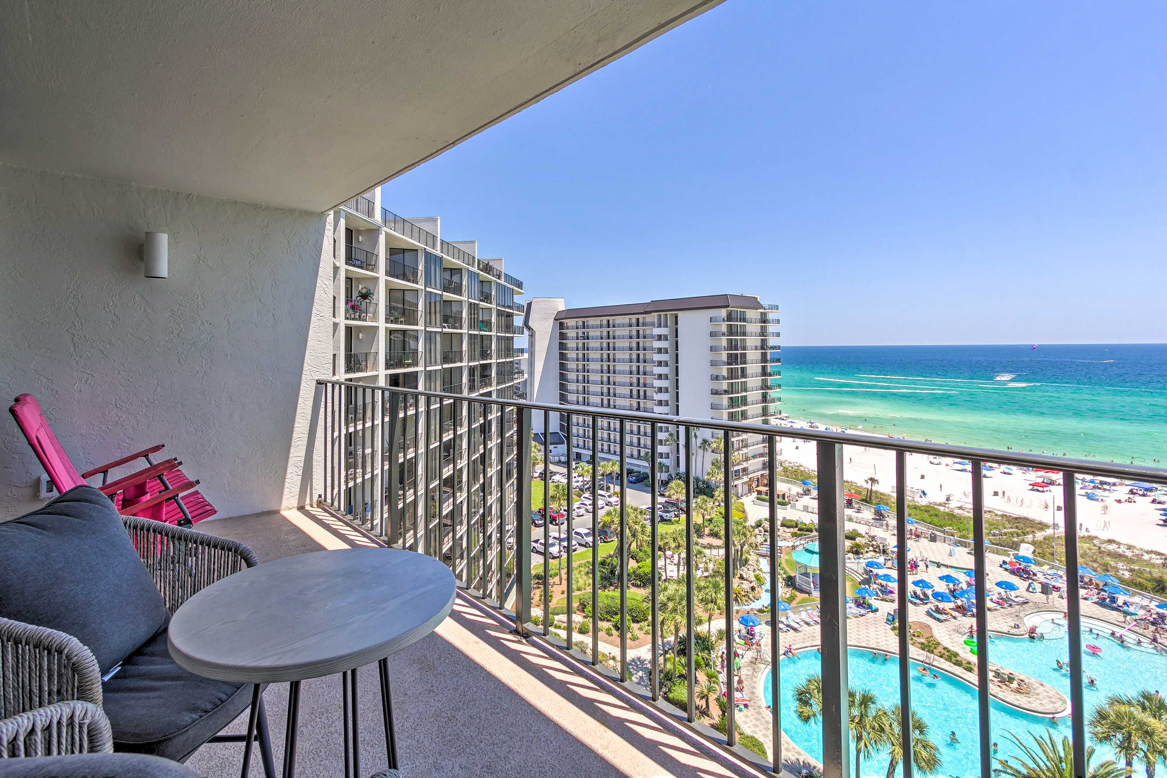 The condo offers a private balcony with views of the beach & pool.