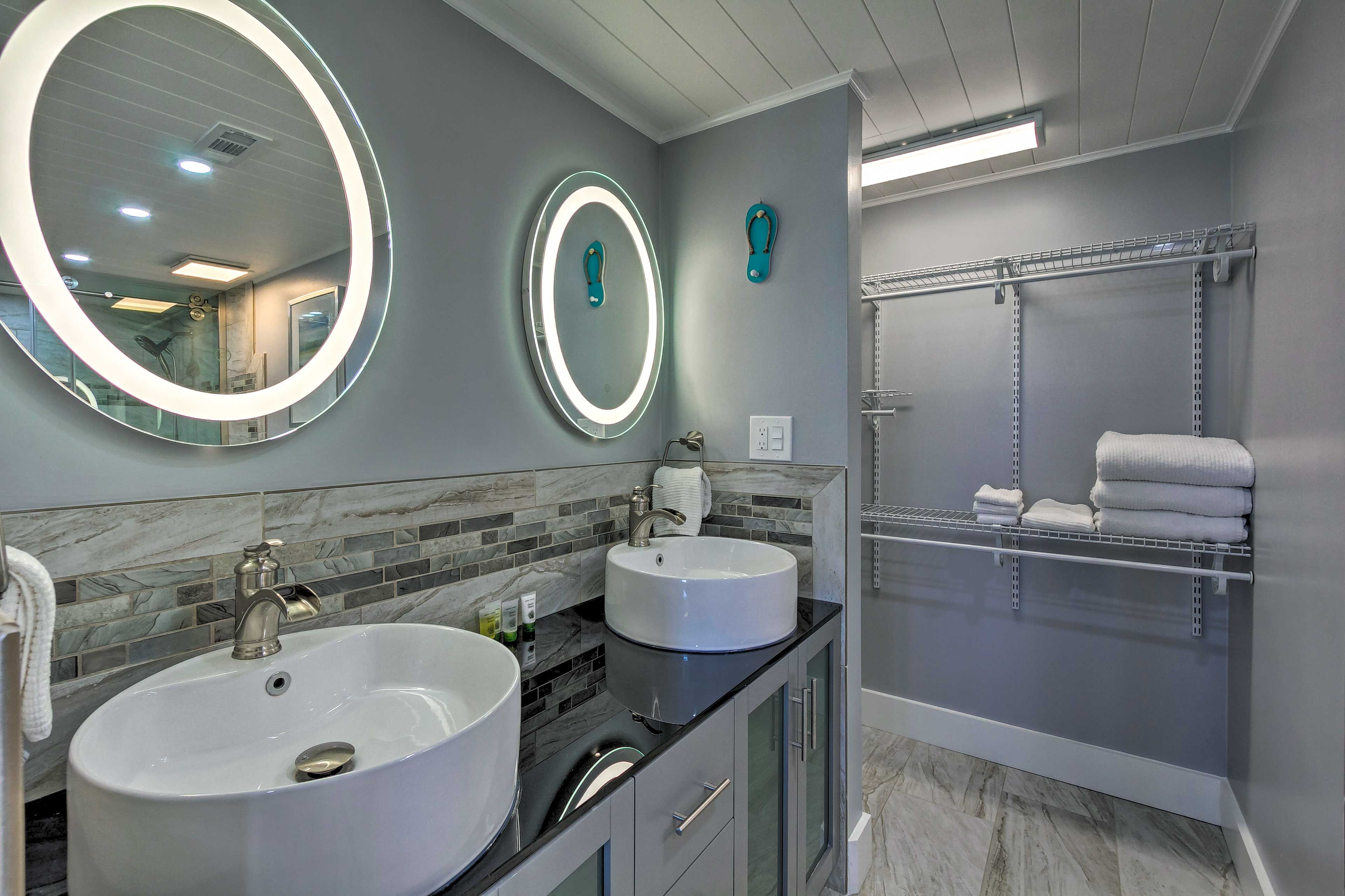 Mirrors with ring lighting add a little flair to this bathroom.