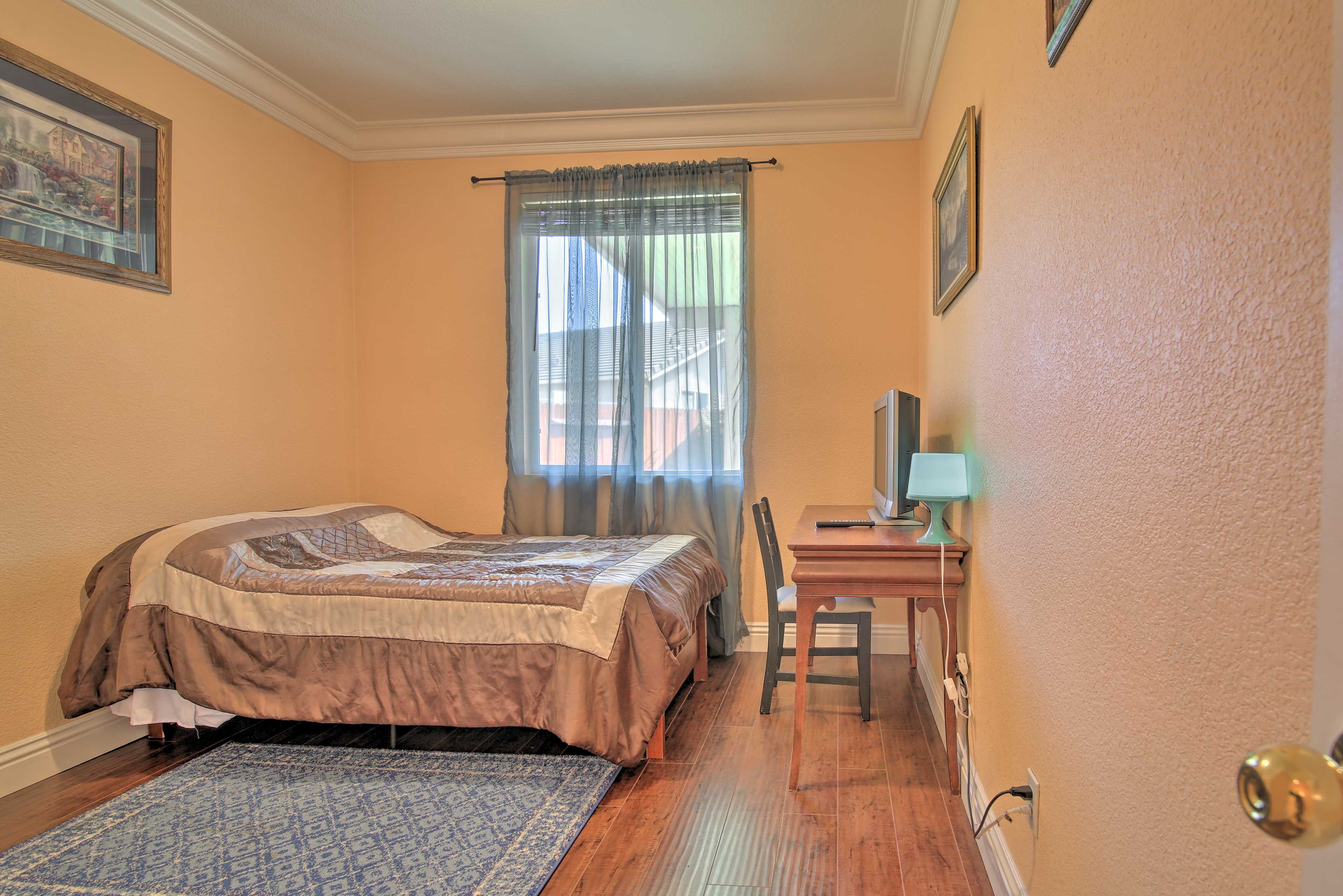 The bedroom features a queen bed.