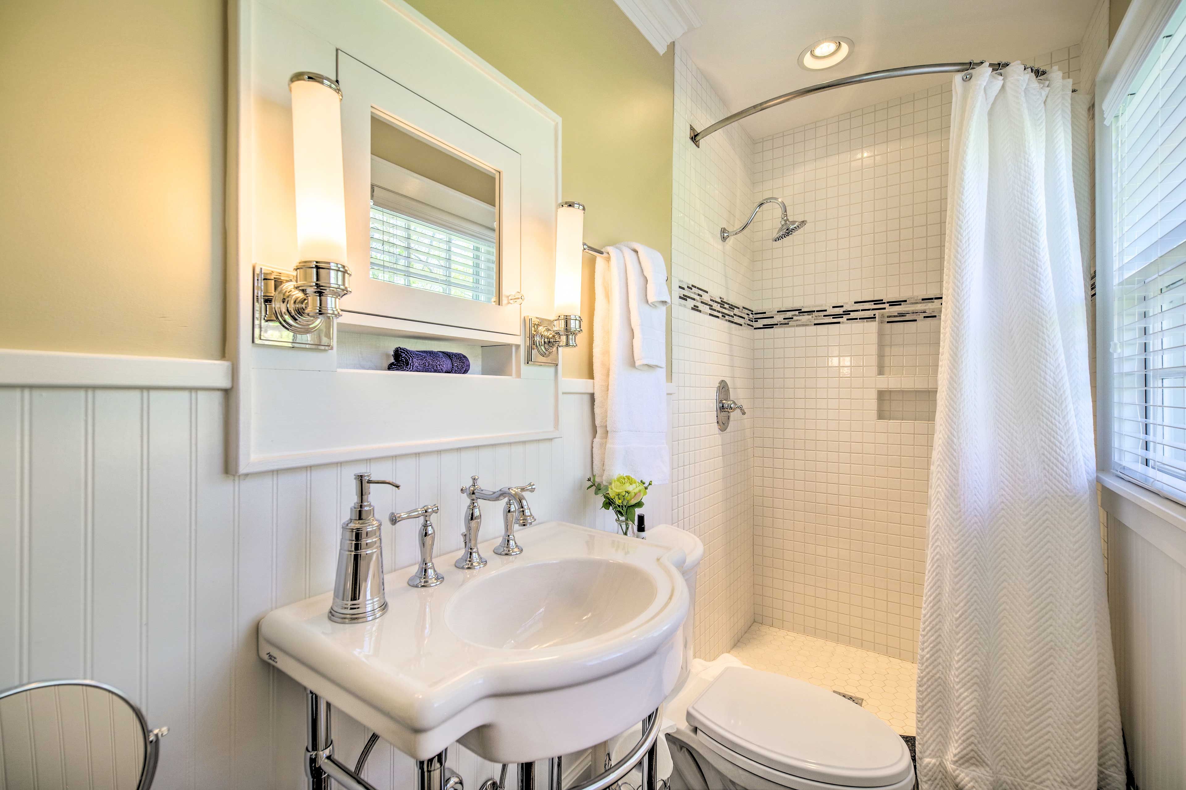 Enjoy freshening up in this charming bathroom.