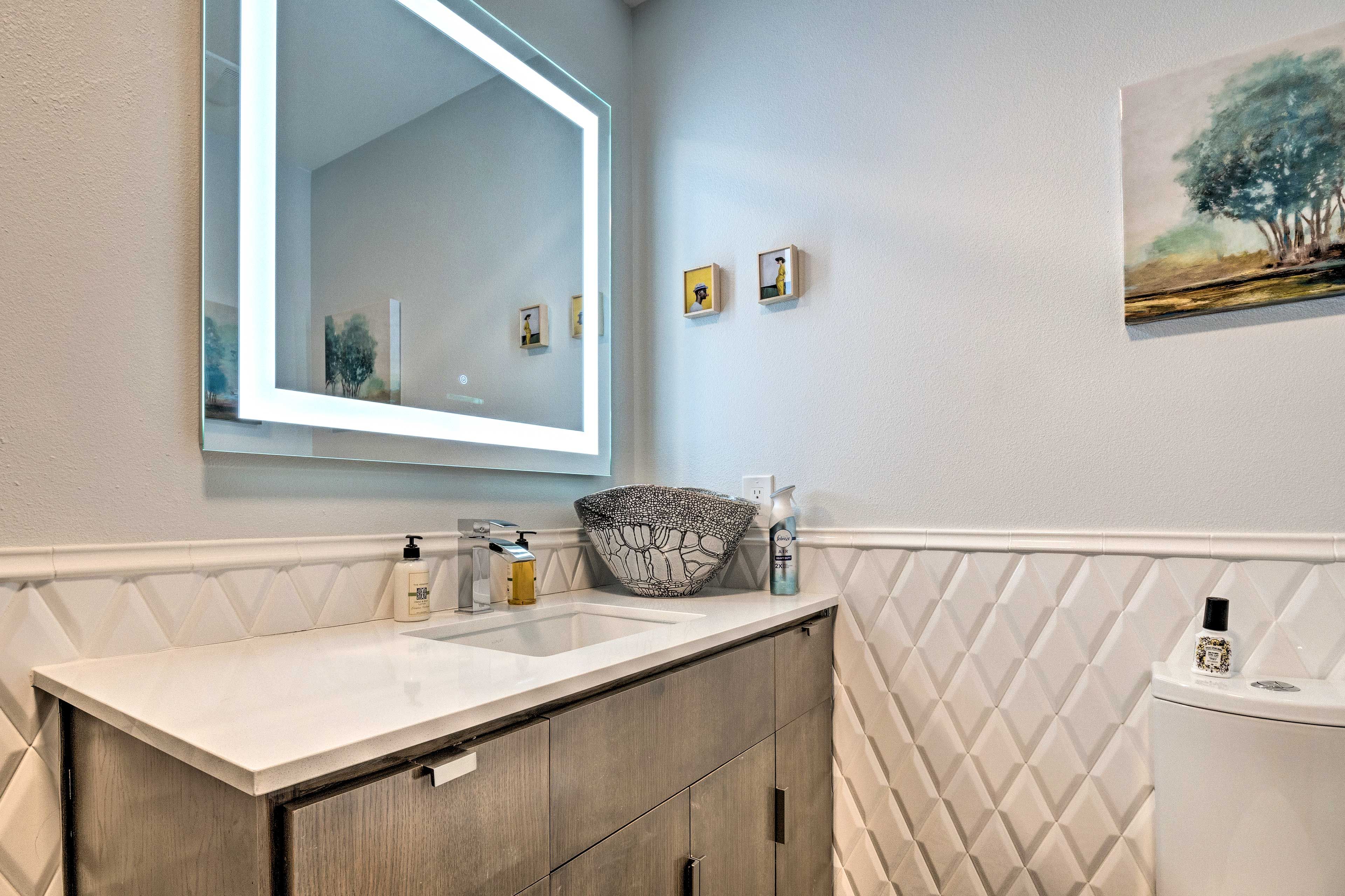 There is an additional half bathroom in the main living space.