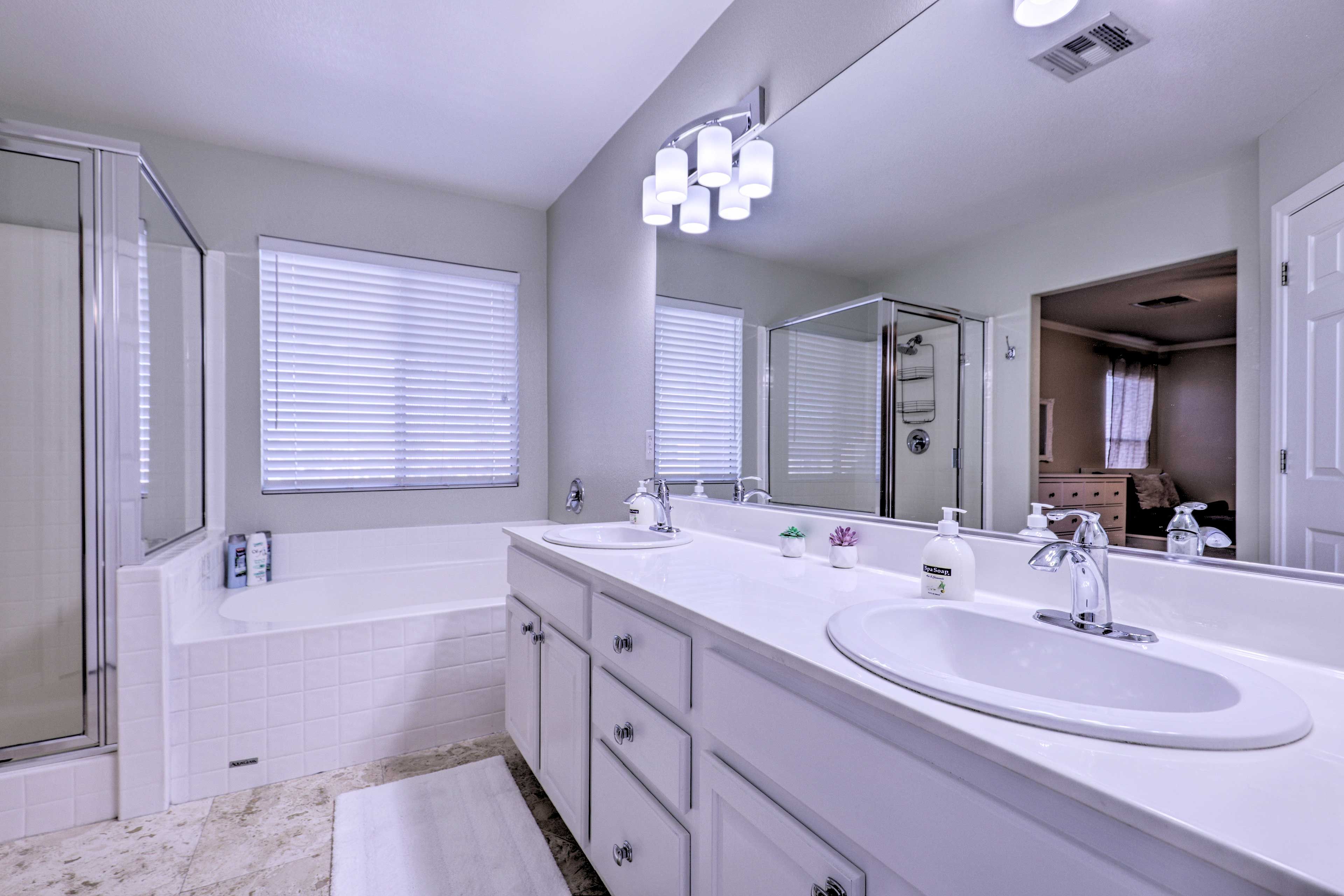 The en-suite bath boasts a walk-in shower, soaking tub, and dual sinks.