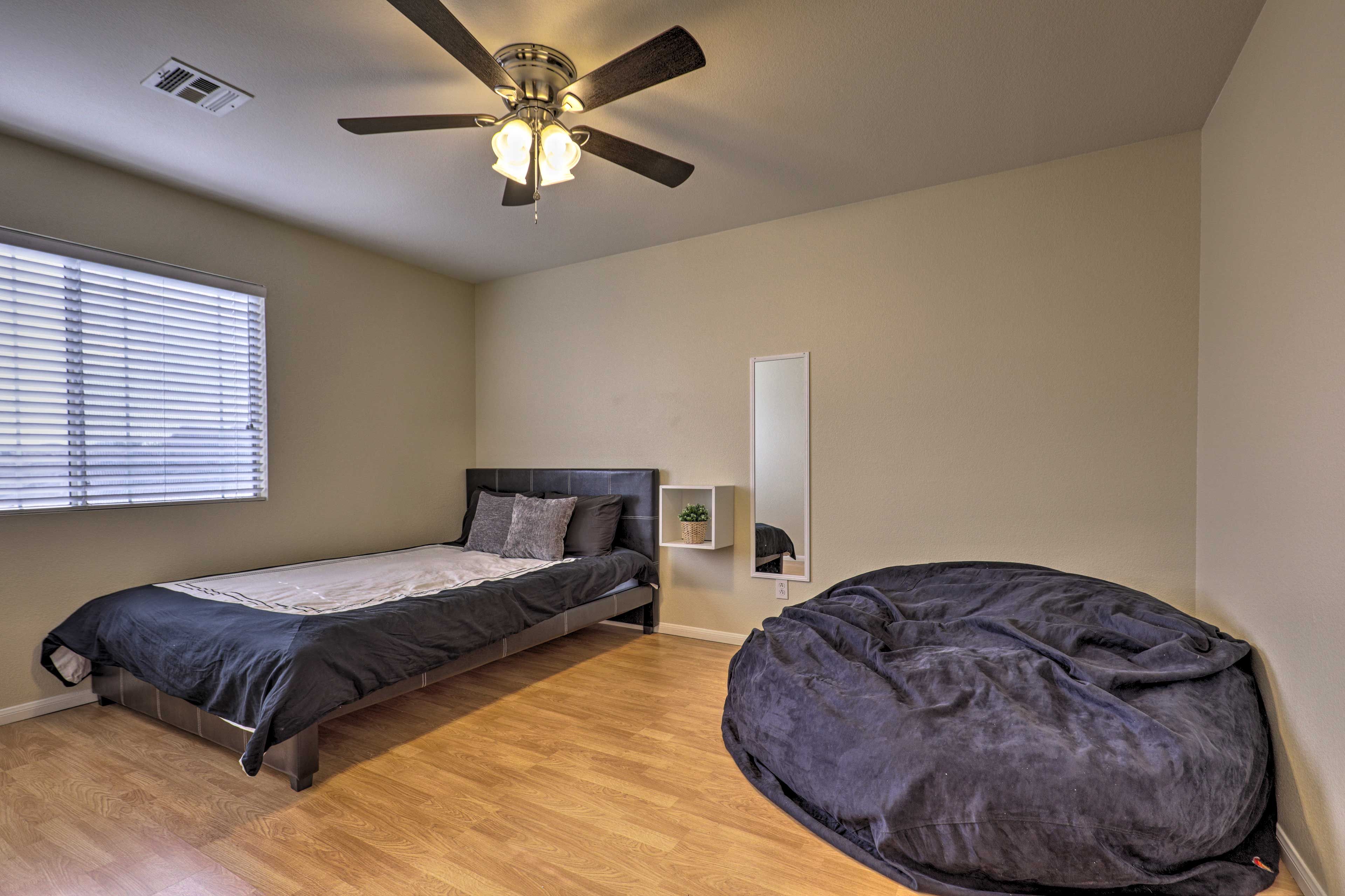 This 3rd bedroom offers a queen bed and bean bag.