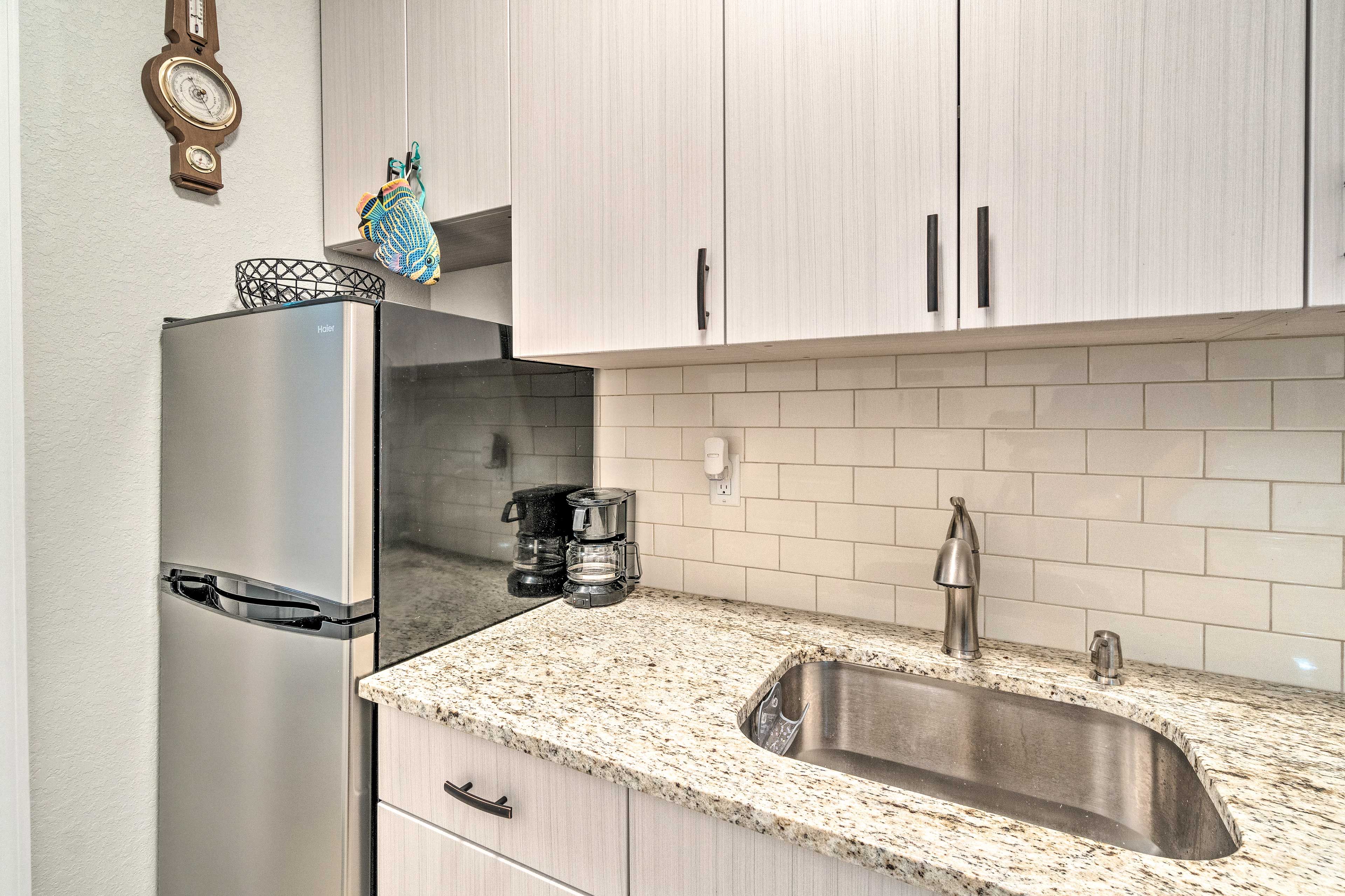 The kitchen has expansive countertops and top appliances.