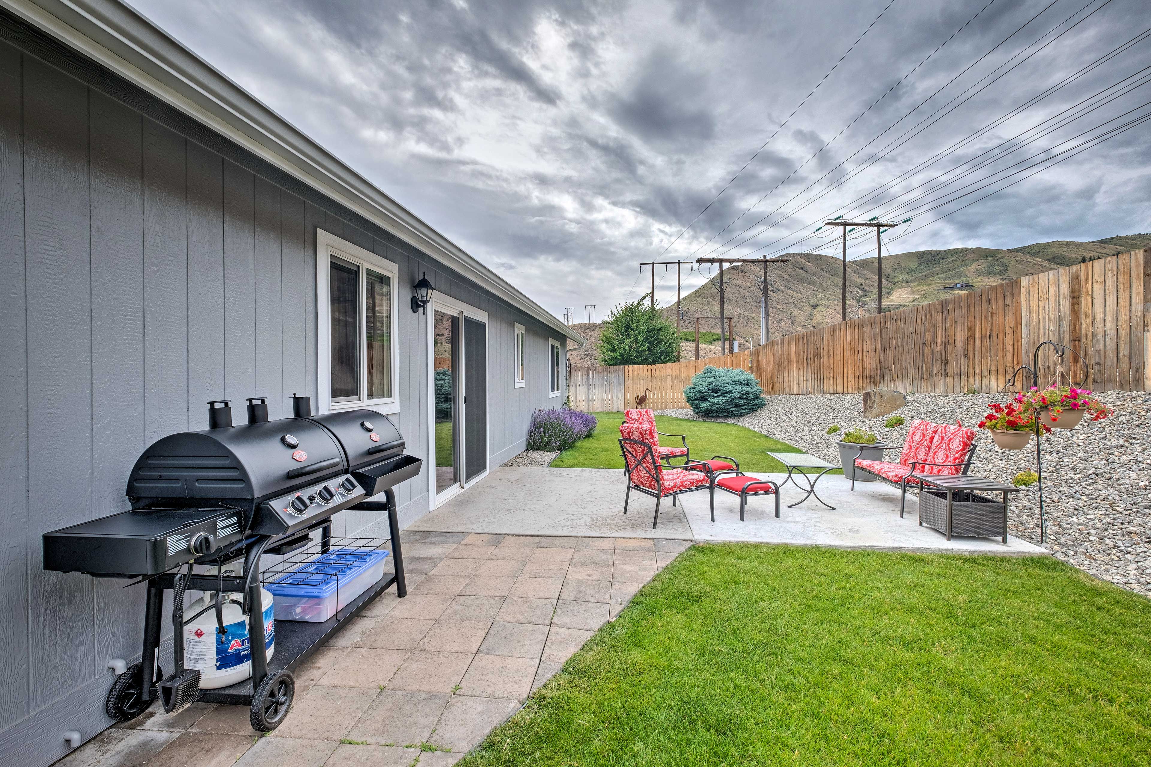 Outside, the patio boasts a gas grill, smokers, and plenty of seating.