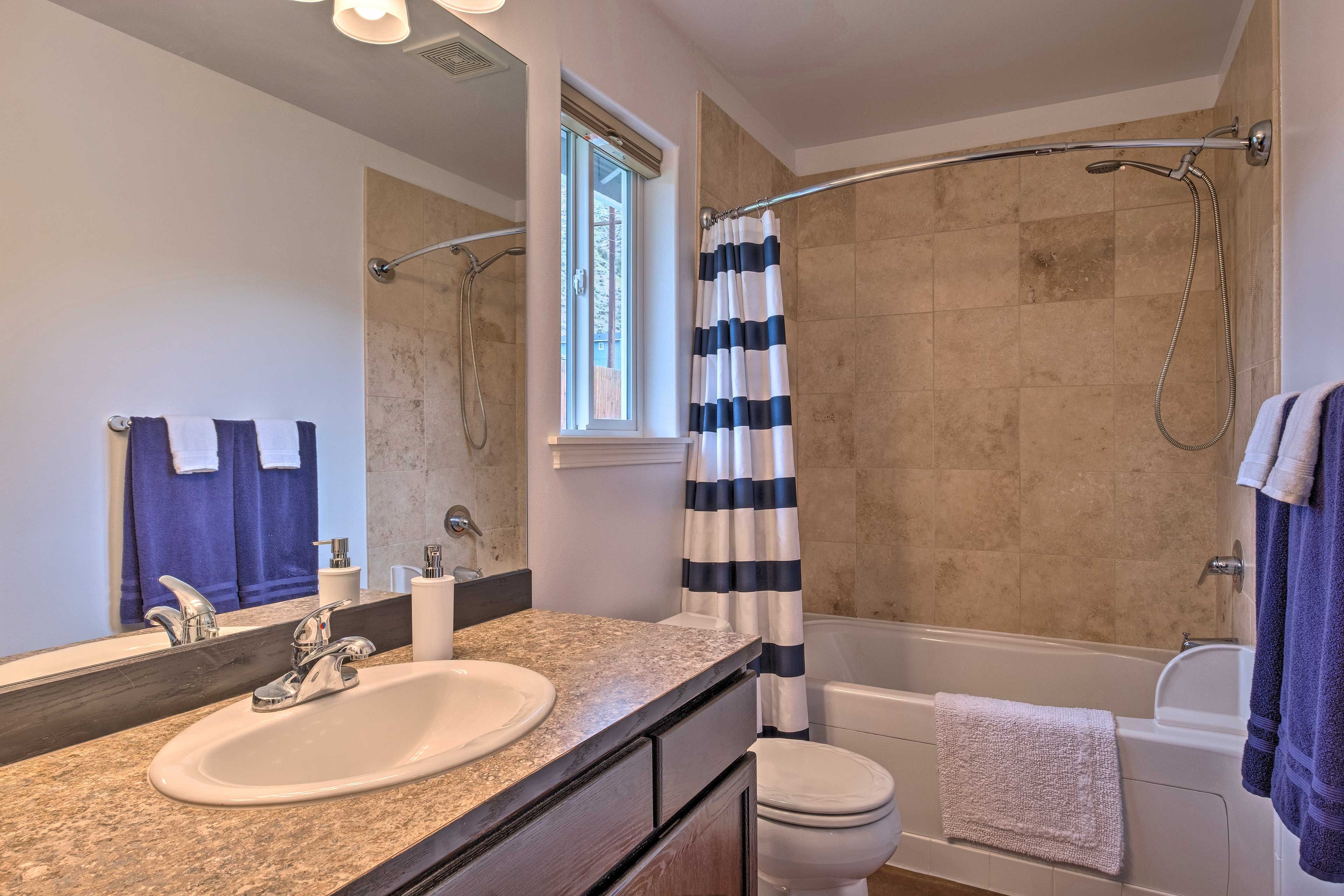 In the en-suite bathroom, find a shower/tub combo.