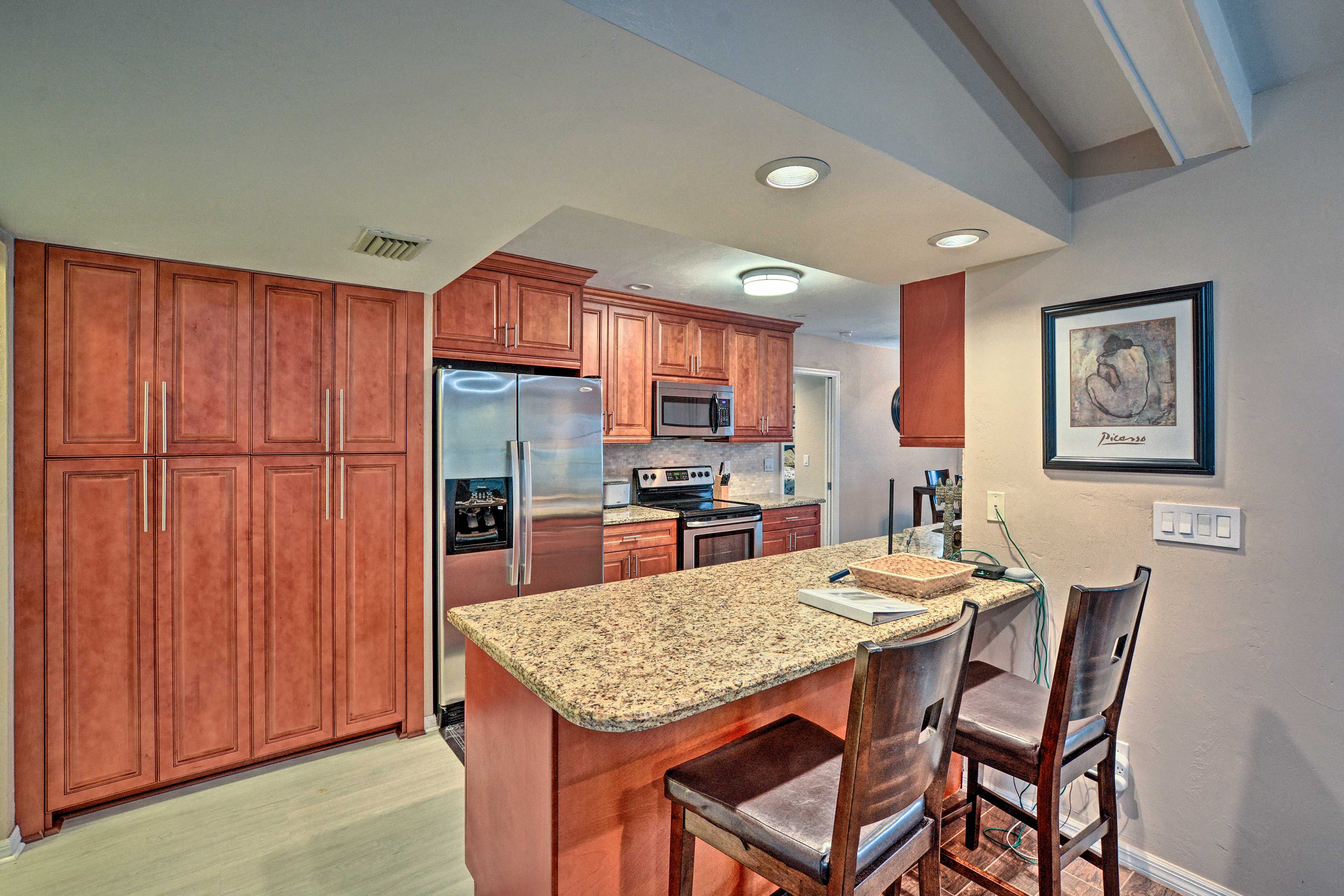 The kitchen features a breakfast bar as well as stainless steel appliances.