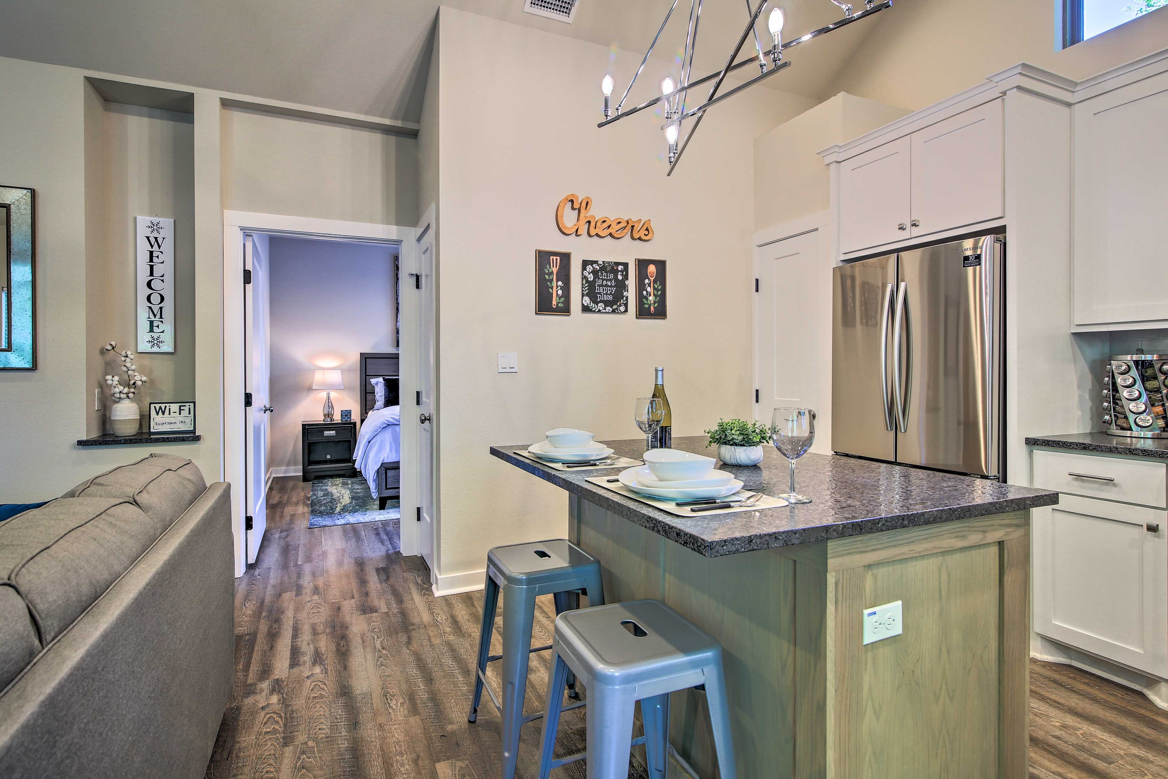 The full kitchen is outfitted with stainless steel appliances.