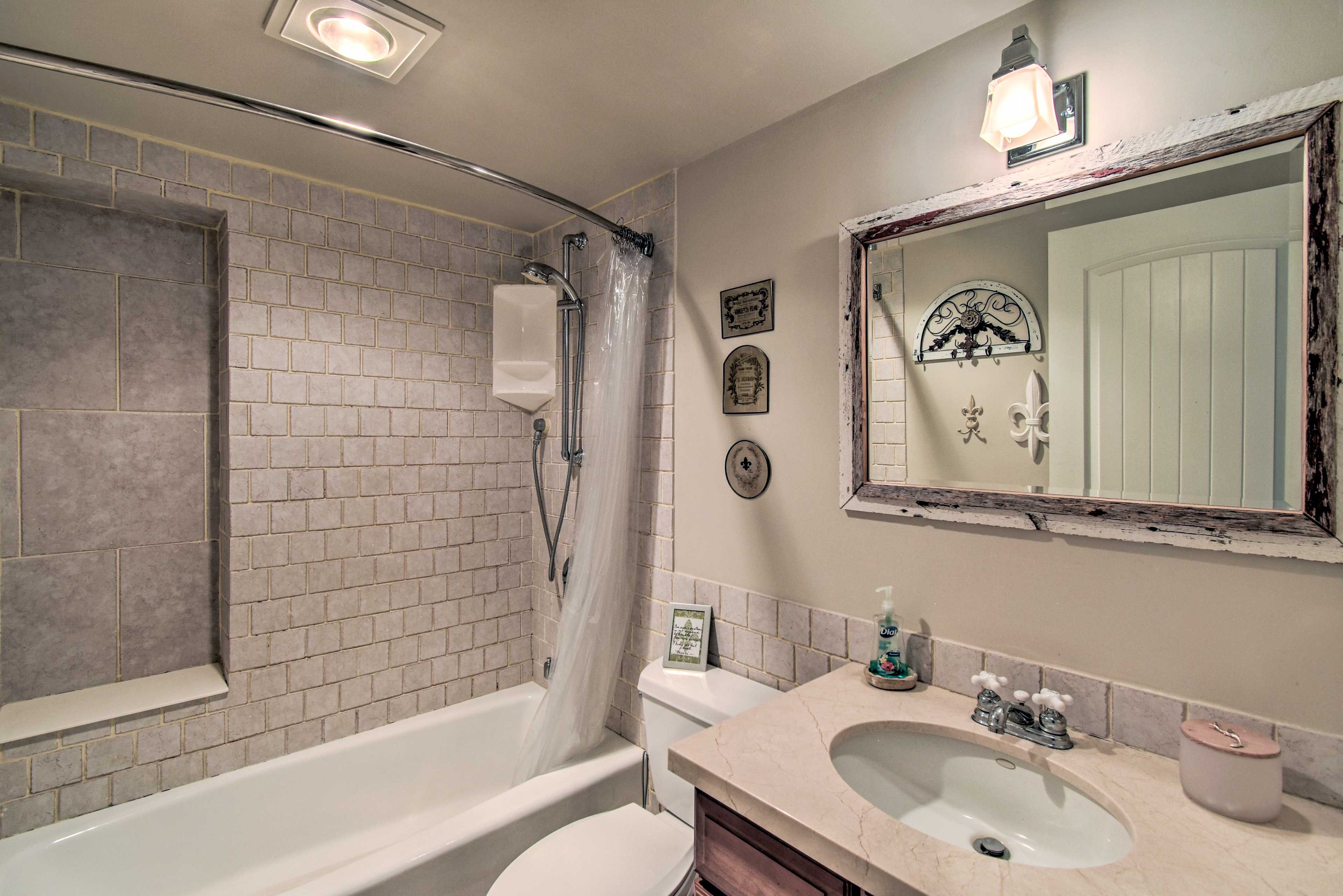 The first bathroom has a shower/tub combo.