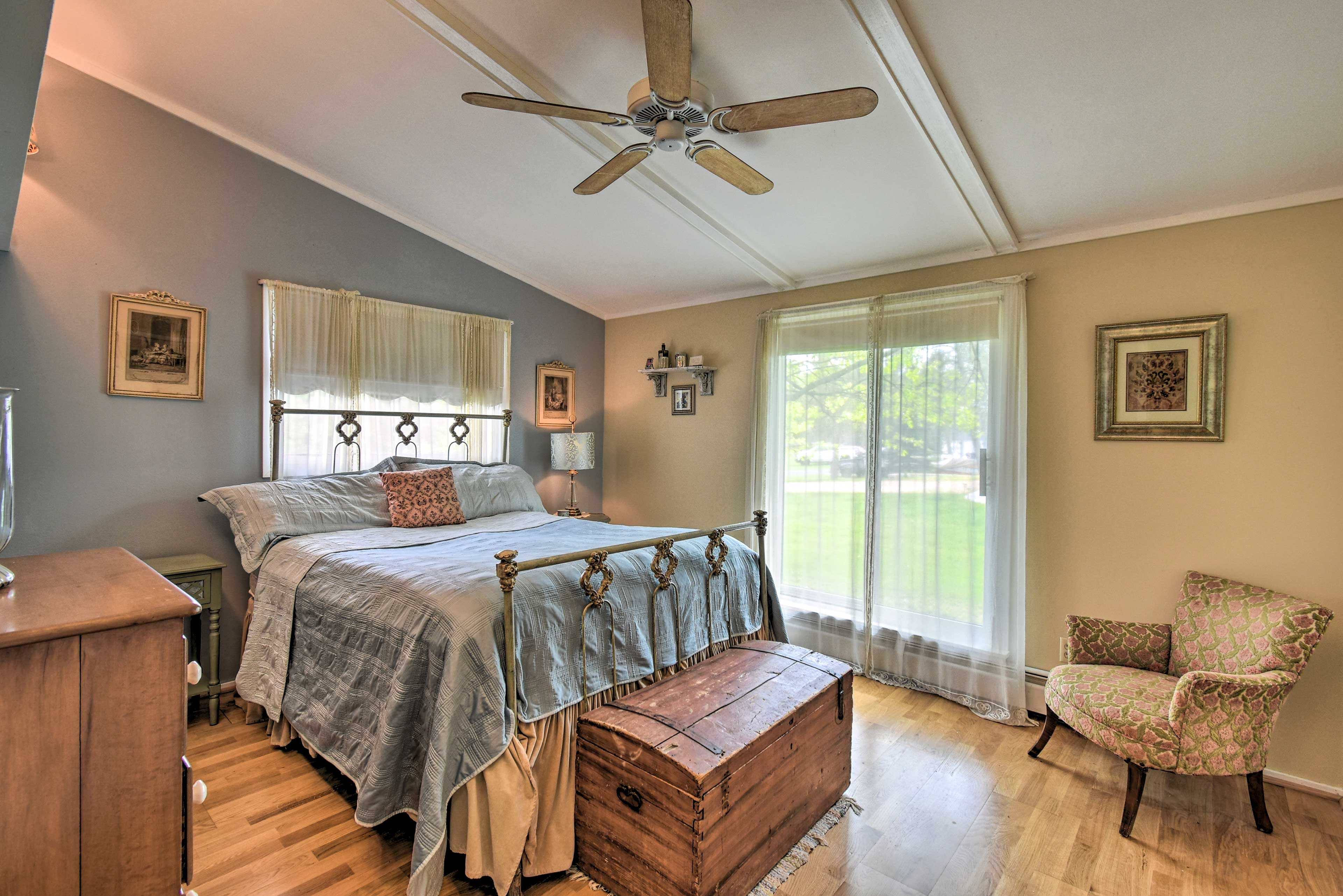 The first bedroom features a queen-sized bed and sliding glass doors.