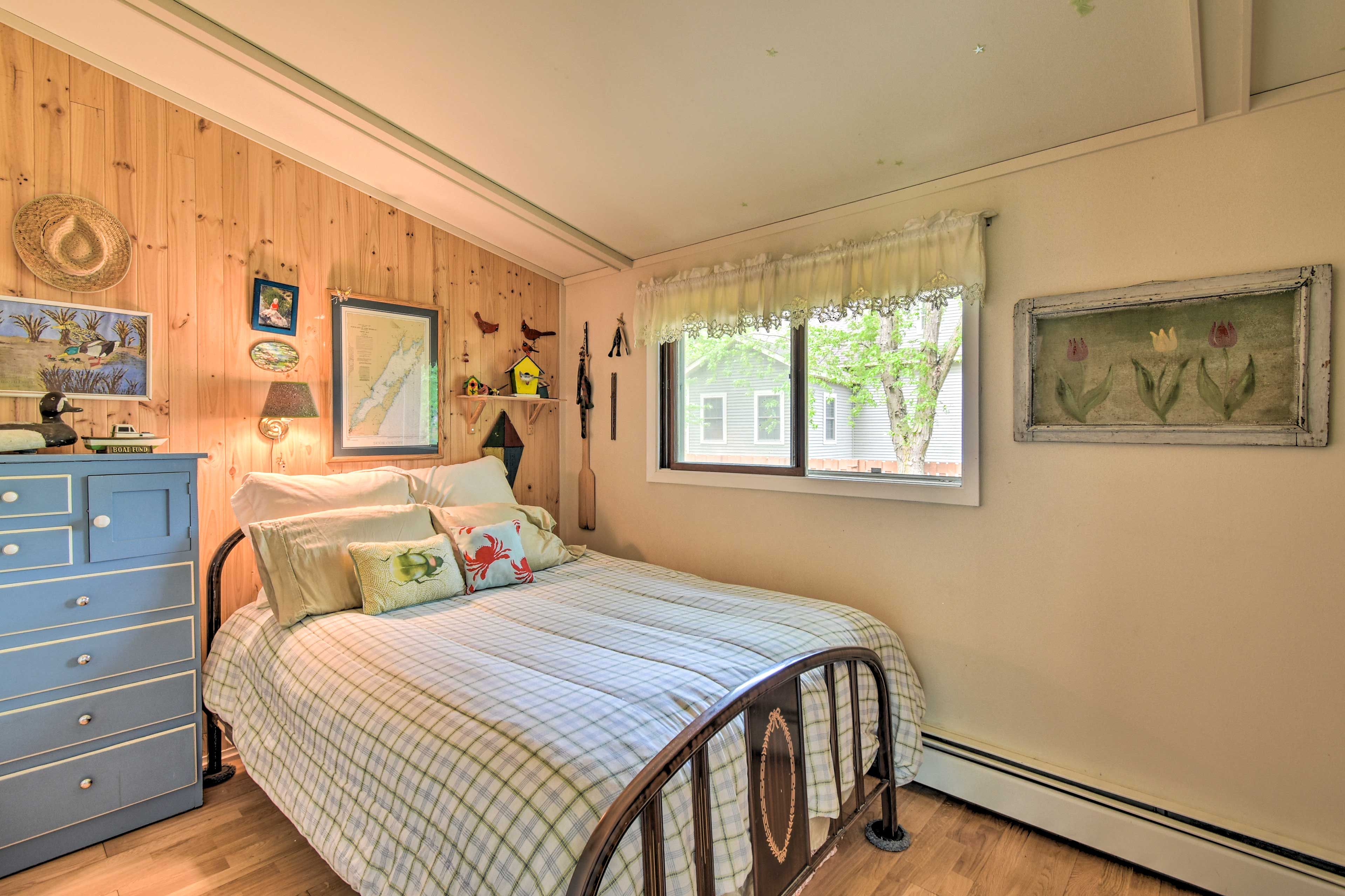 The second bedroom features a queen-sized bed and birdhouse-theme.