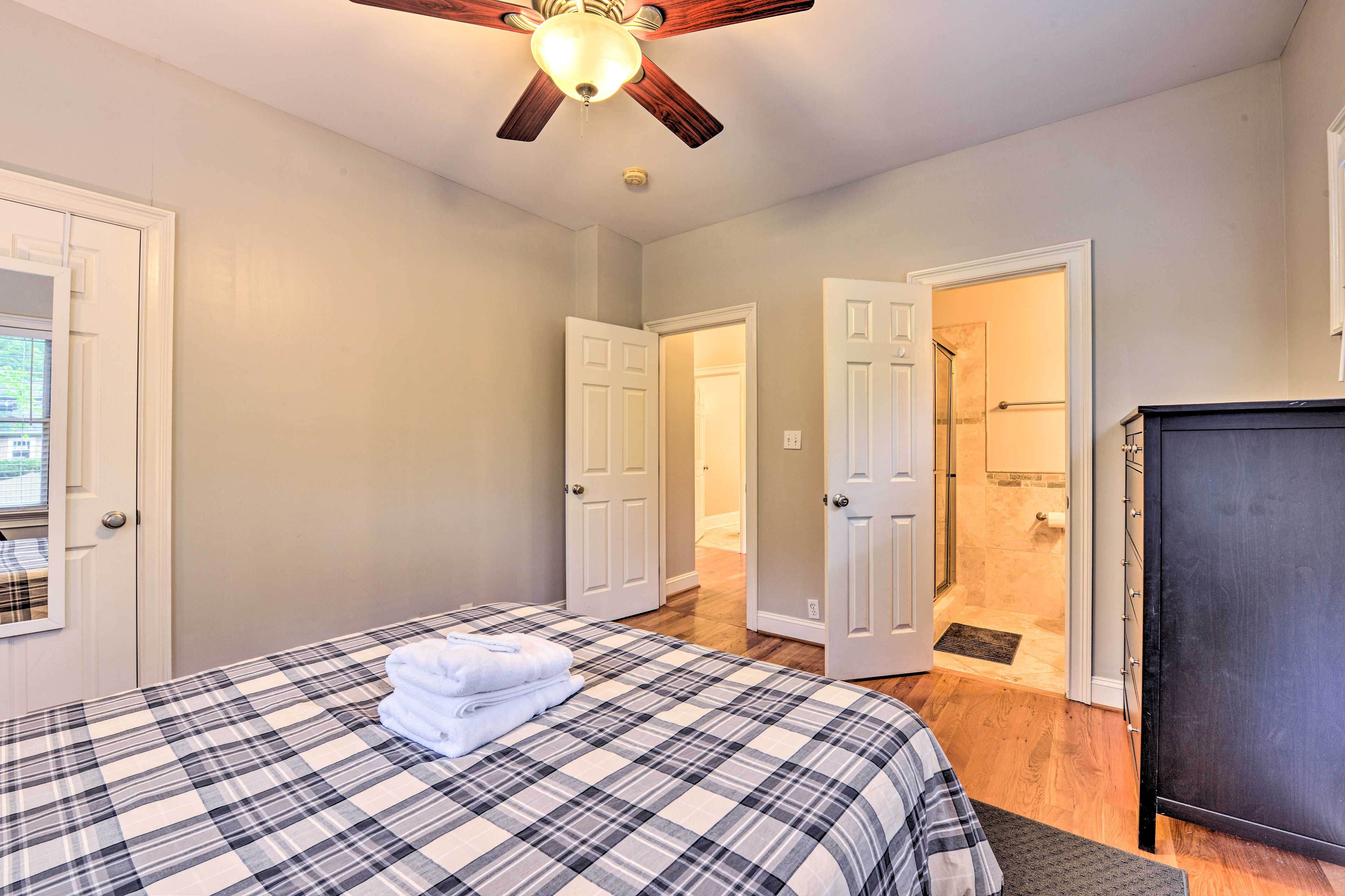 This bedroom features an en-suite bathroom and a queen bed.