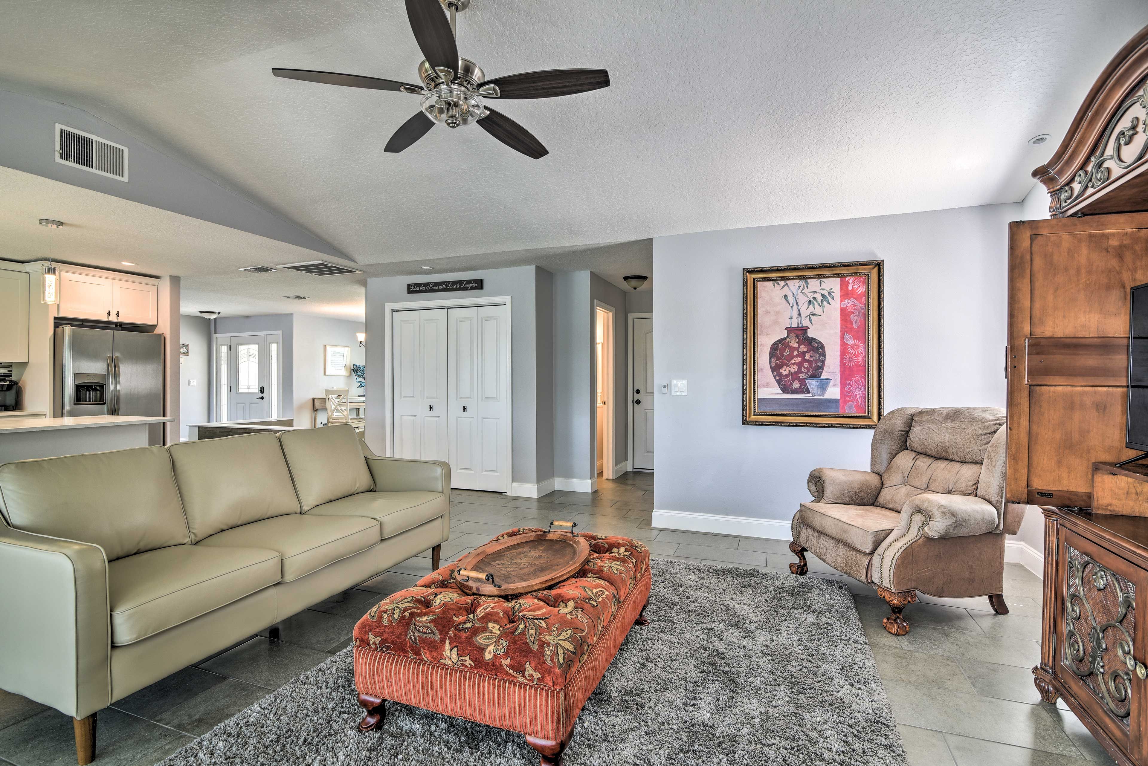 The living area features tasteful decor and vaulted ceilings.