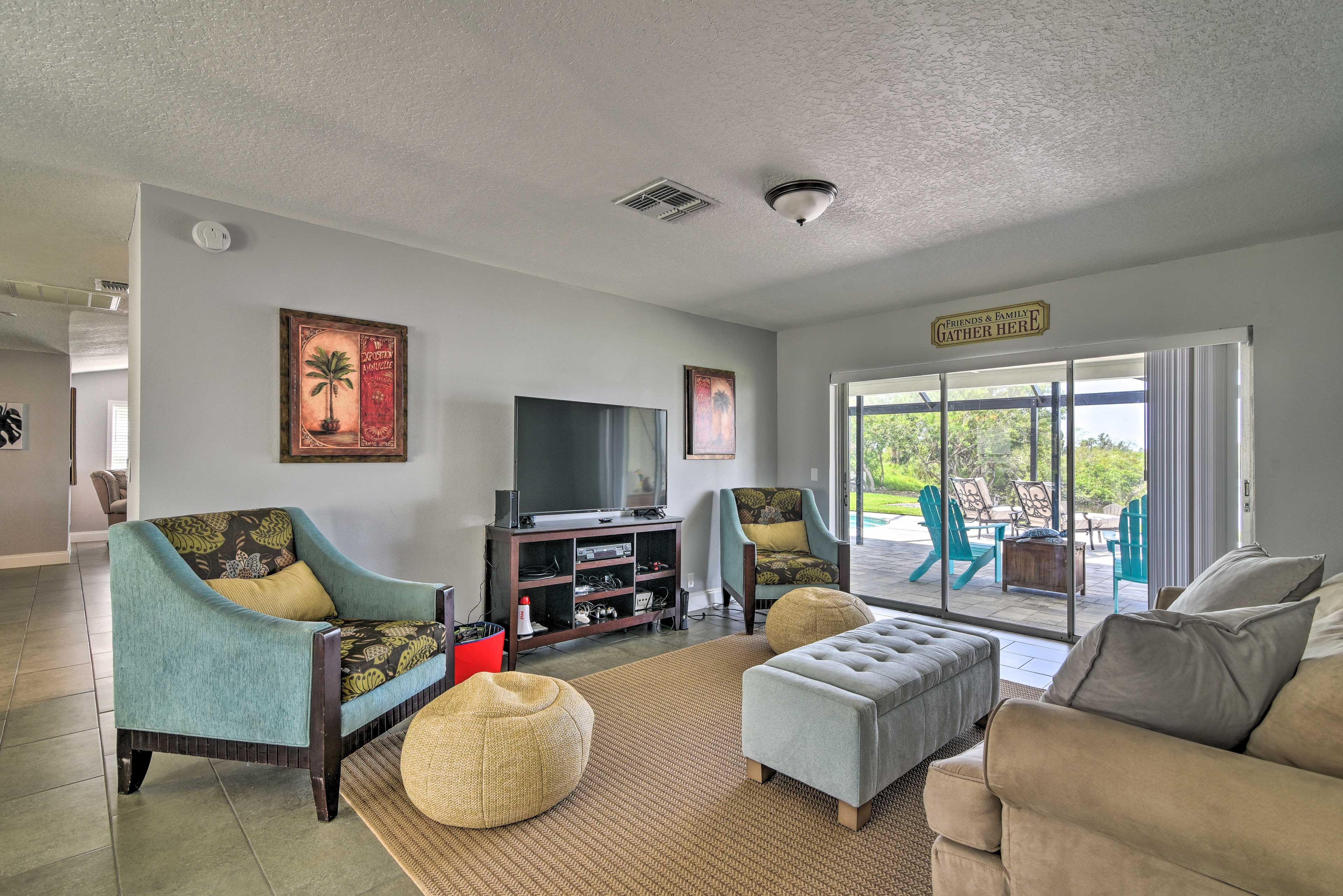 The second living space features a flat-screen TV and sliding glass doors.