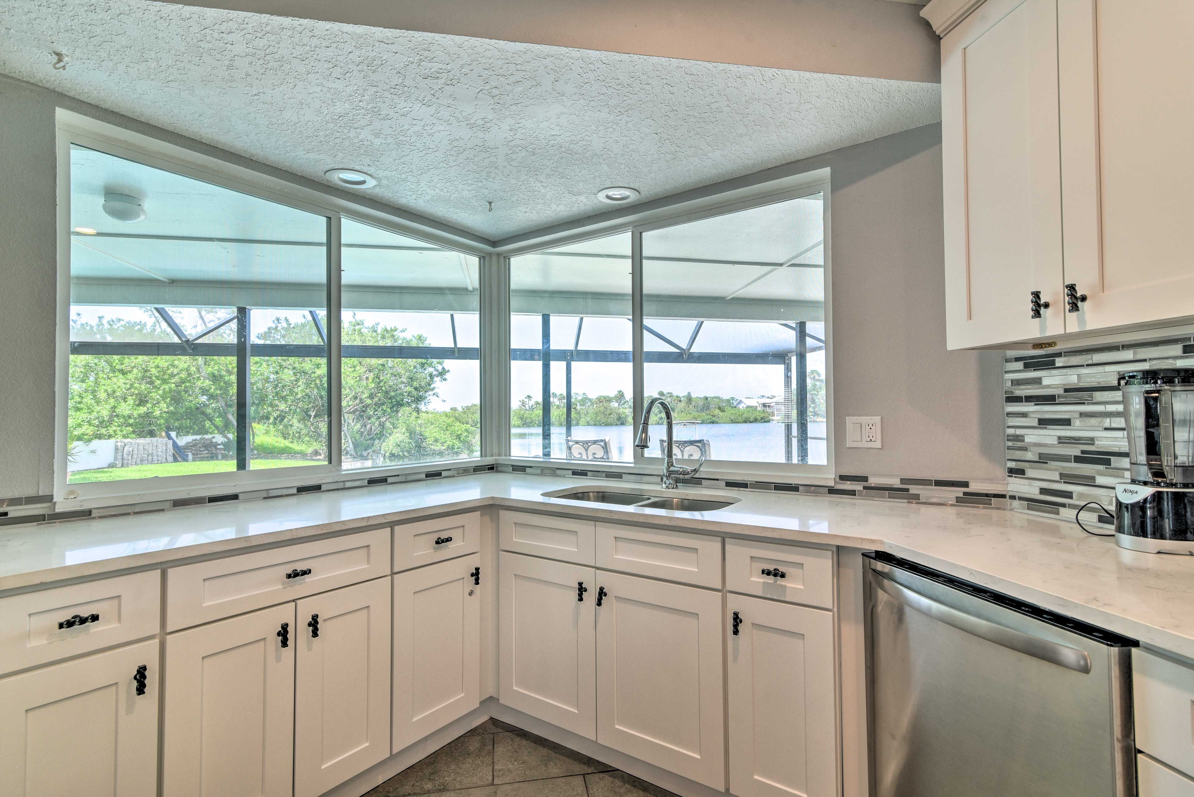 This kitchen features stainless steel appliances and cooking utensils.
