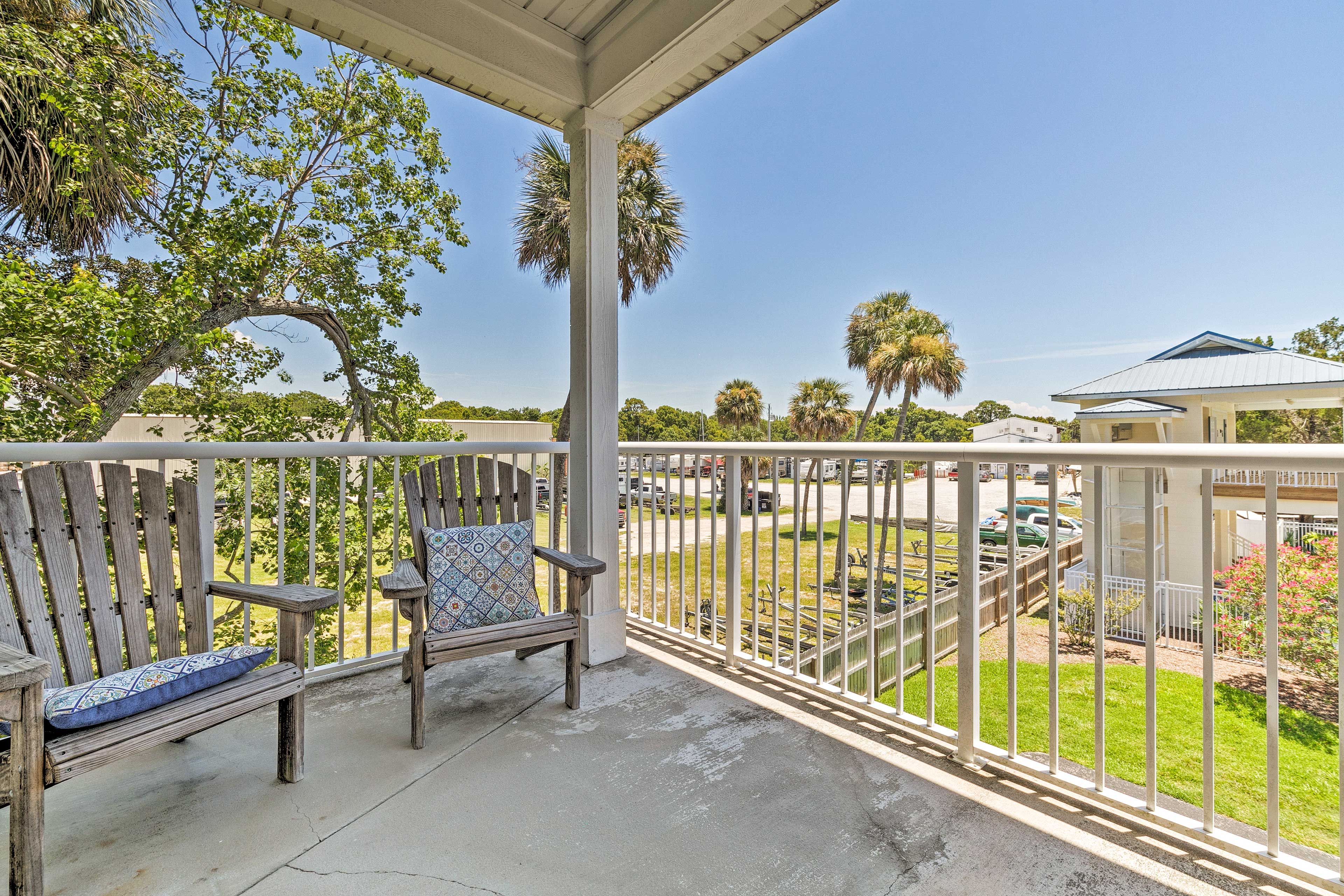 With a furnished balcony, this home offers views of soaring palm trees.