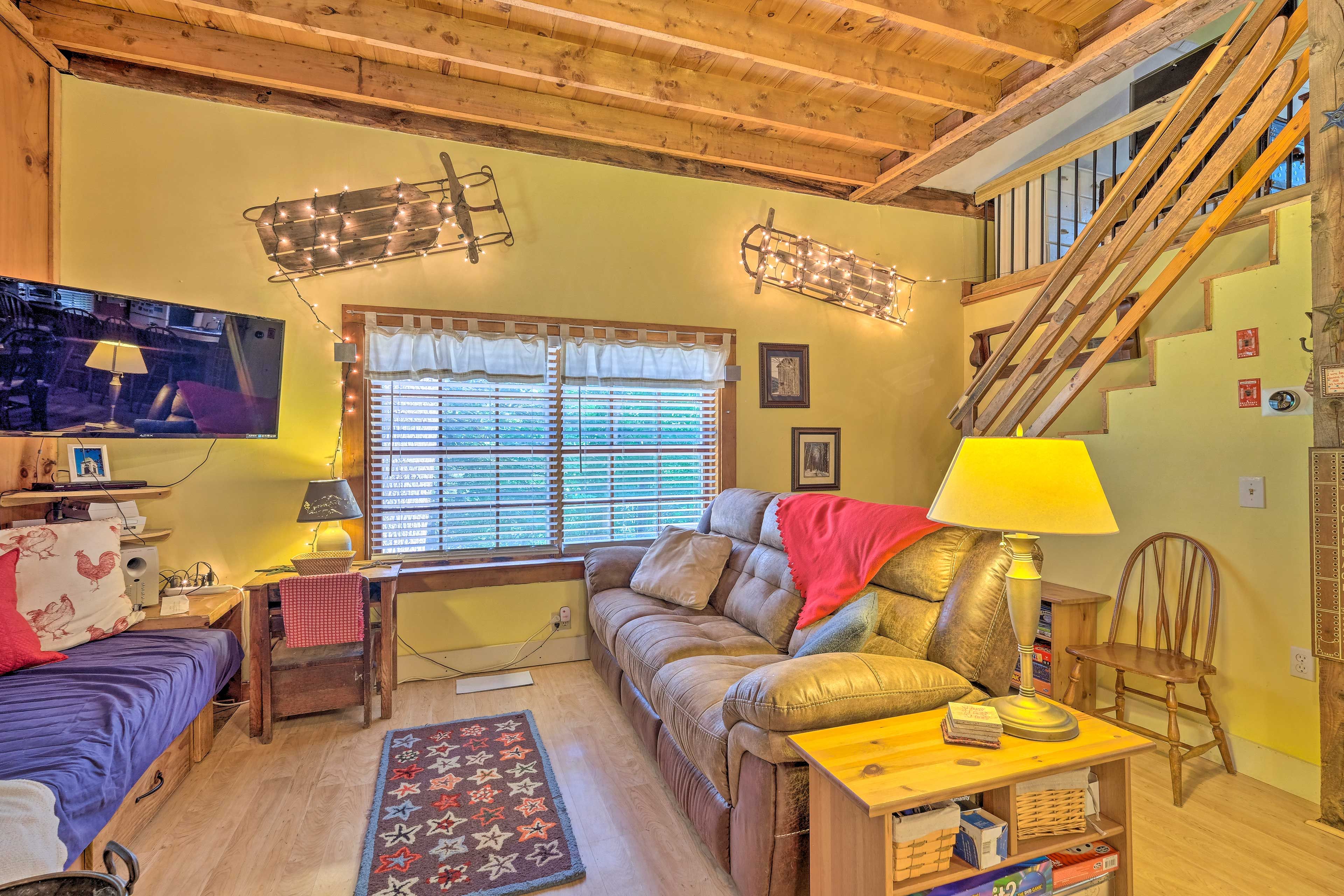The living area features a large flat-screen TV.