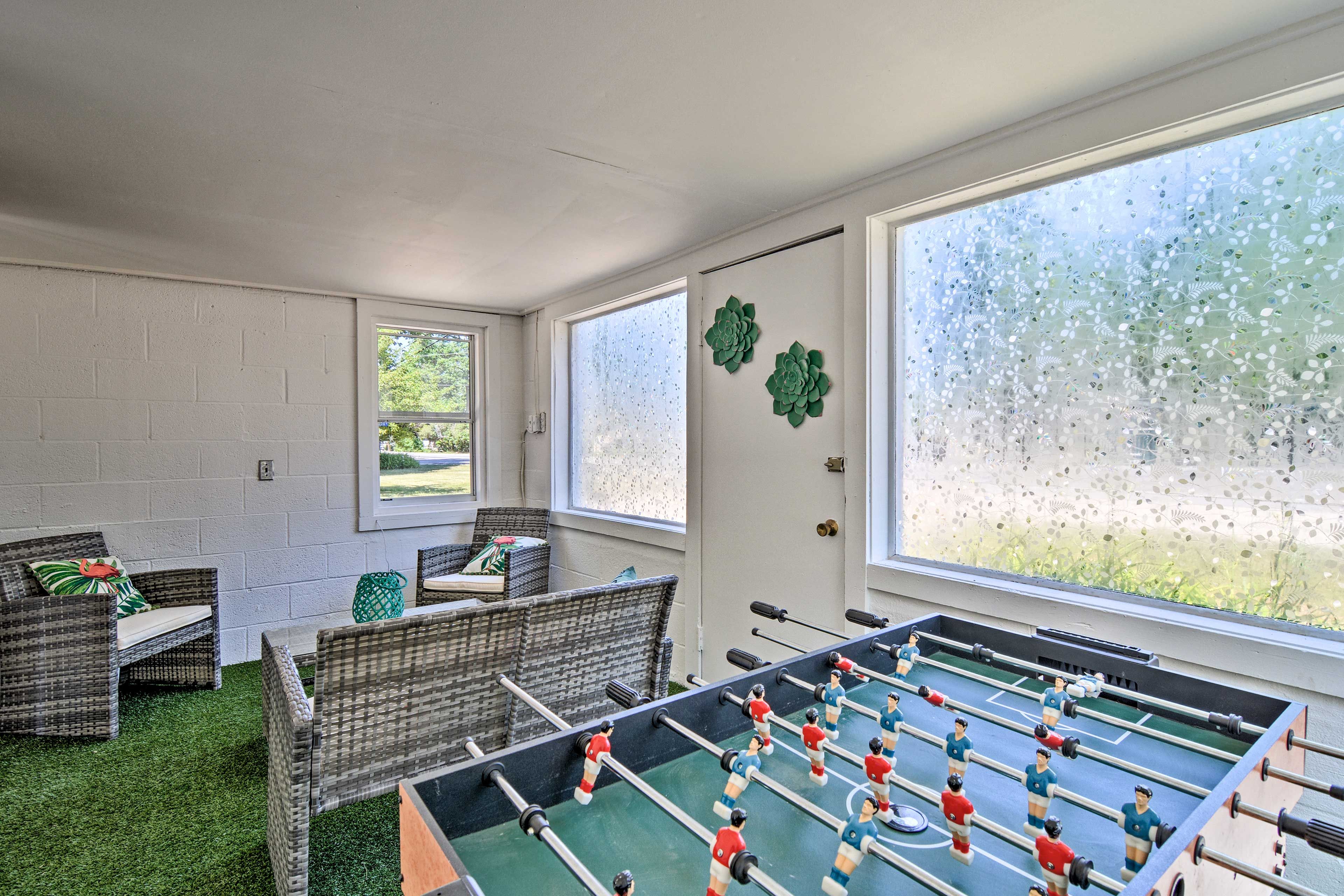 The garden house features a Foosball table & cushioned furniture.