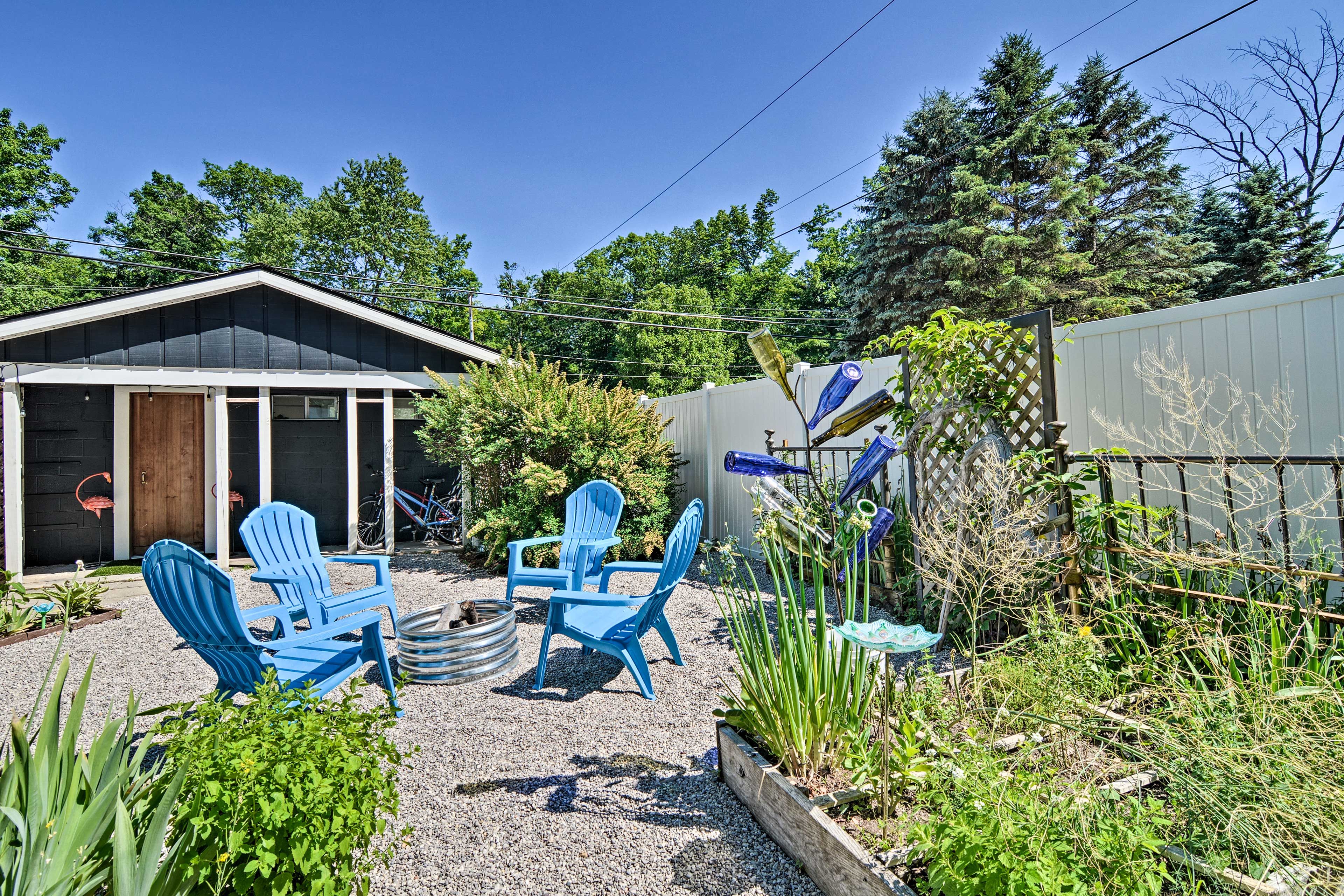 The fenced backyard boasts a garden, fire pit & separate game room.