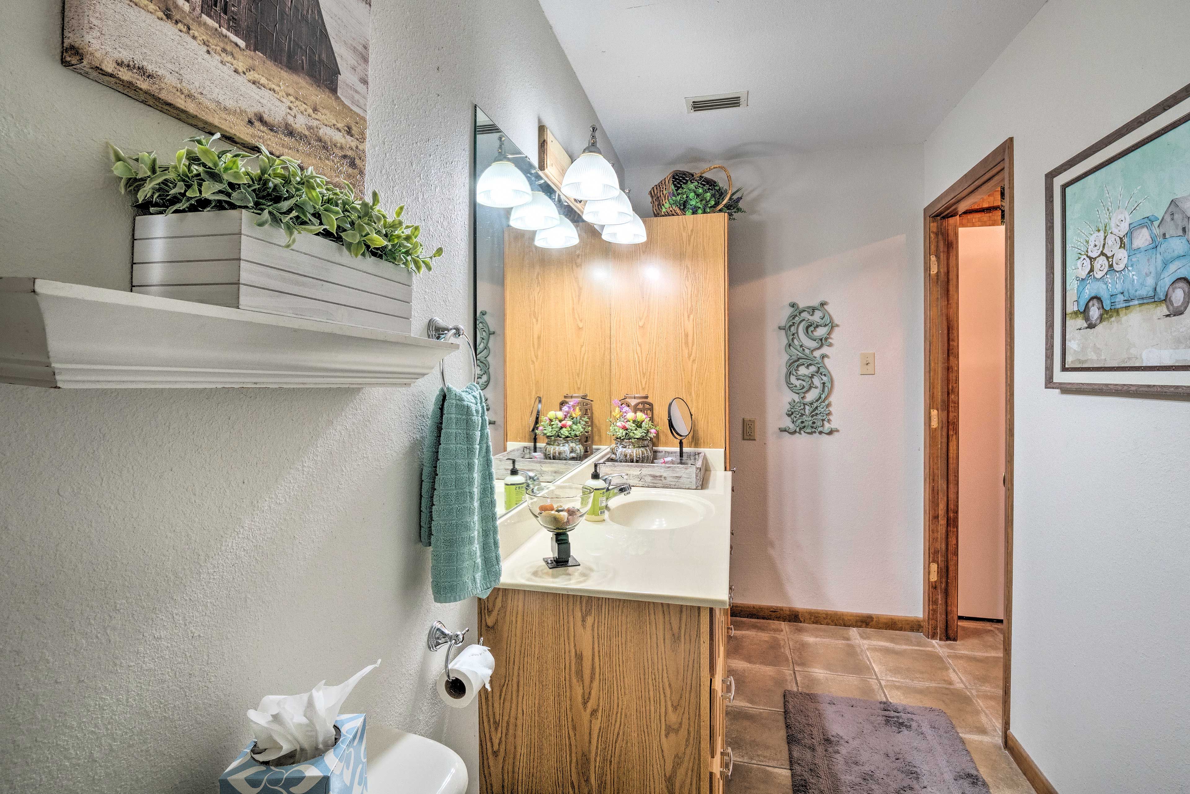 The full bathroom features a walk-in shower and provided towels.