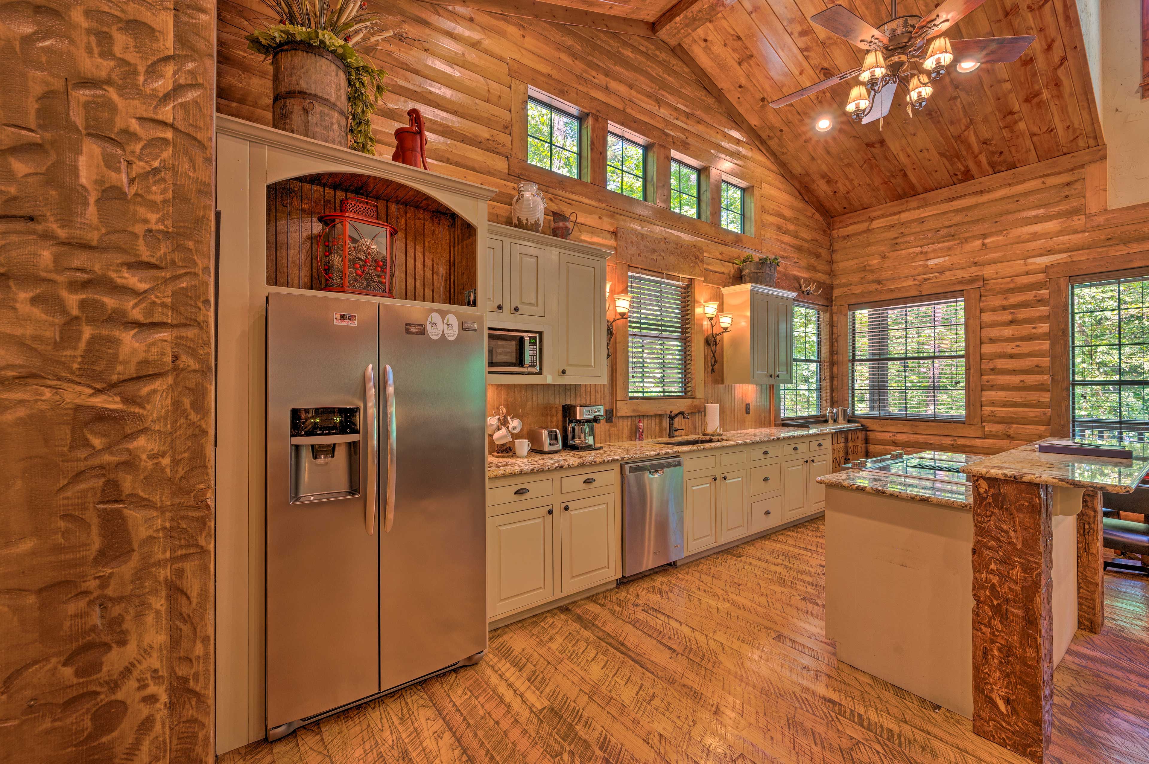 The kitchen is fully equipped with stainless steel appliances and cooking basics