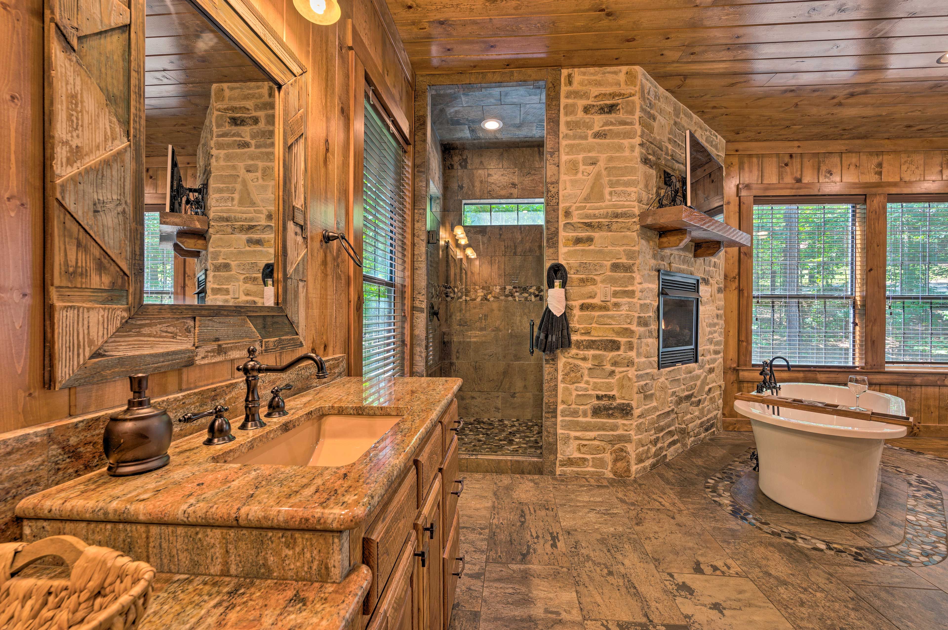 The bathroom features dual sinks and a walk-in shower.