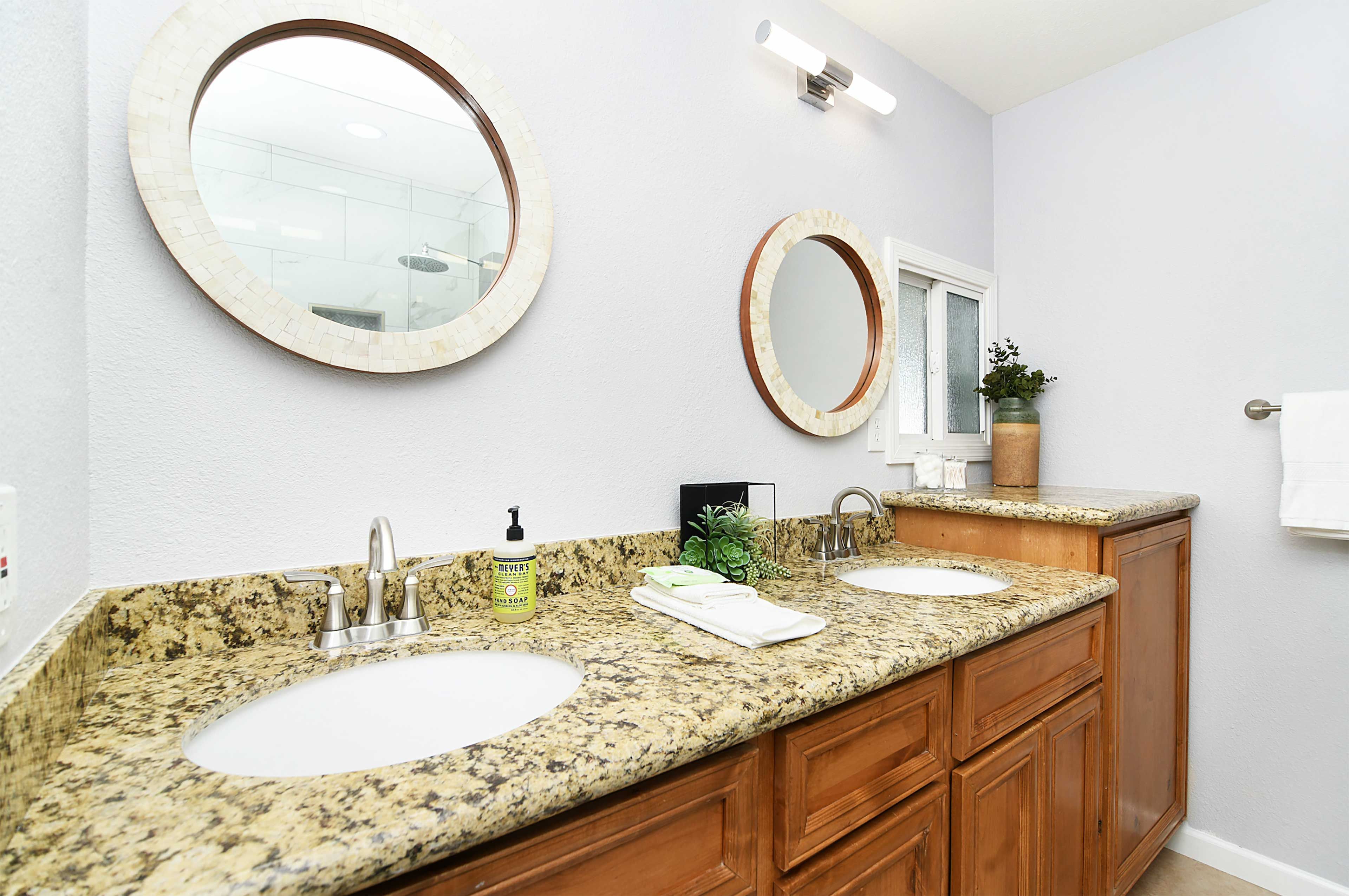 The en-suite bathroom boasts dual sinks and high-end fixtures.