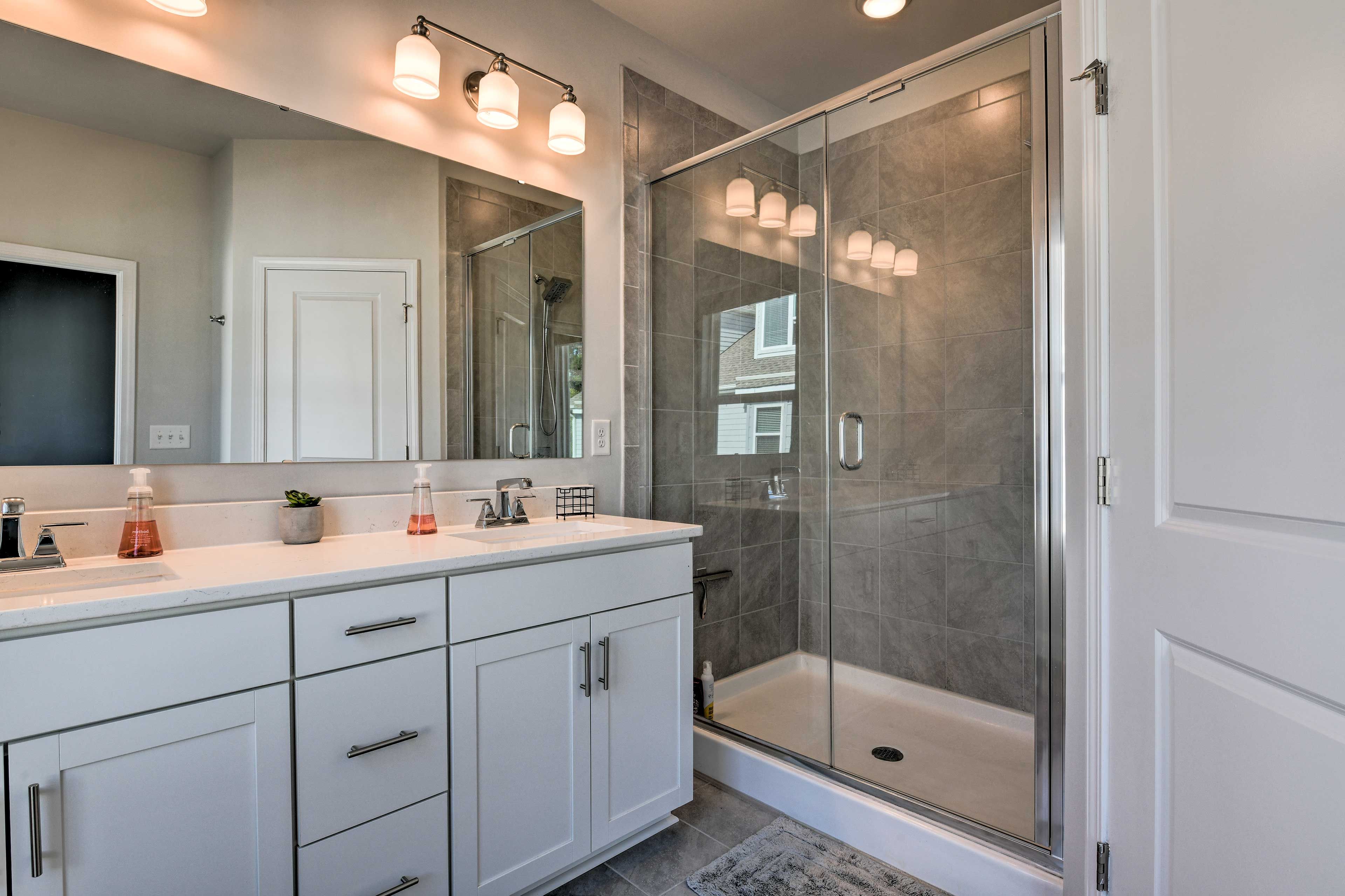 The maser en-suite offers dual sinks and a walk-in shower.