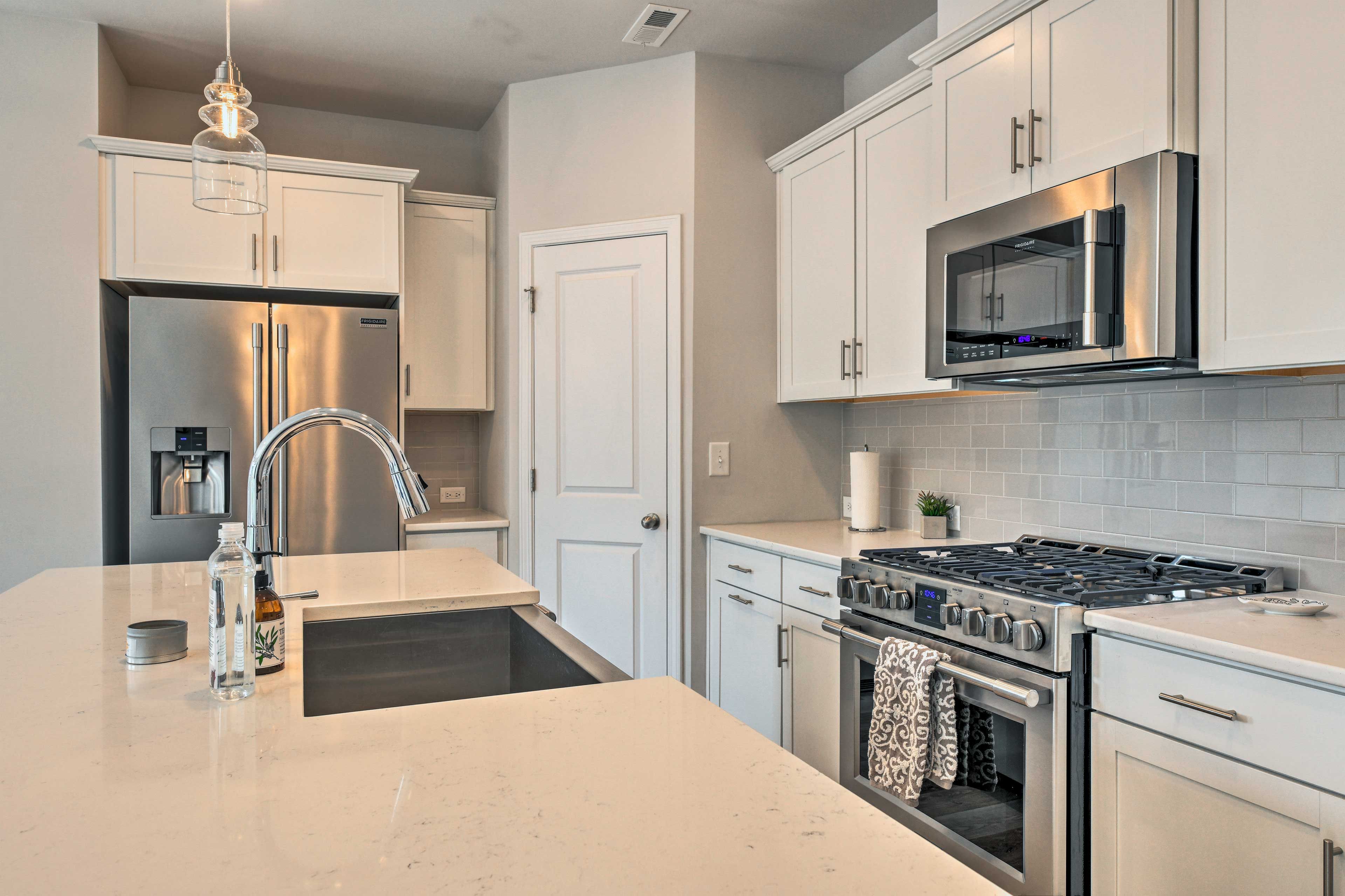 The modern kitchen is complete with new stainless steel appliances.
