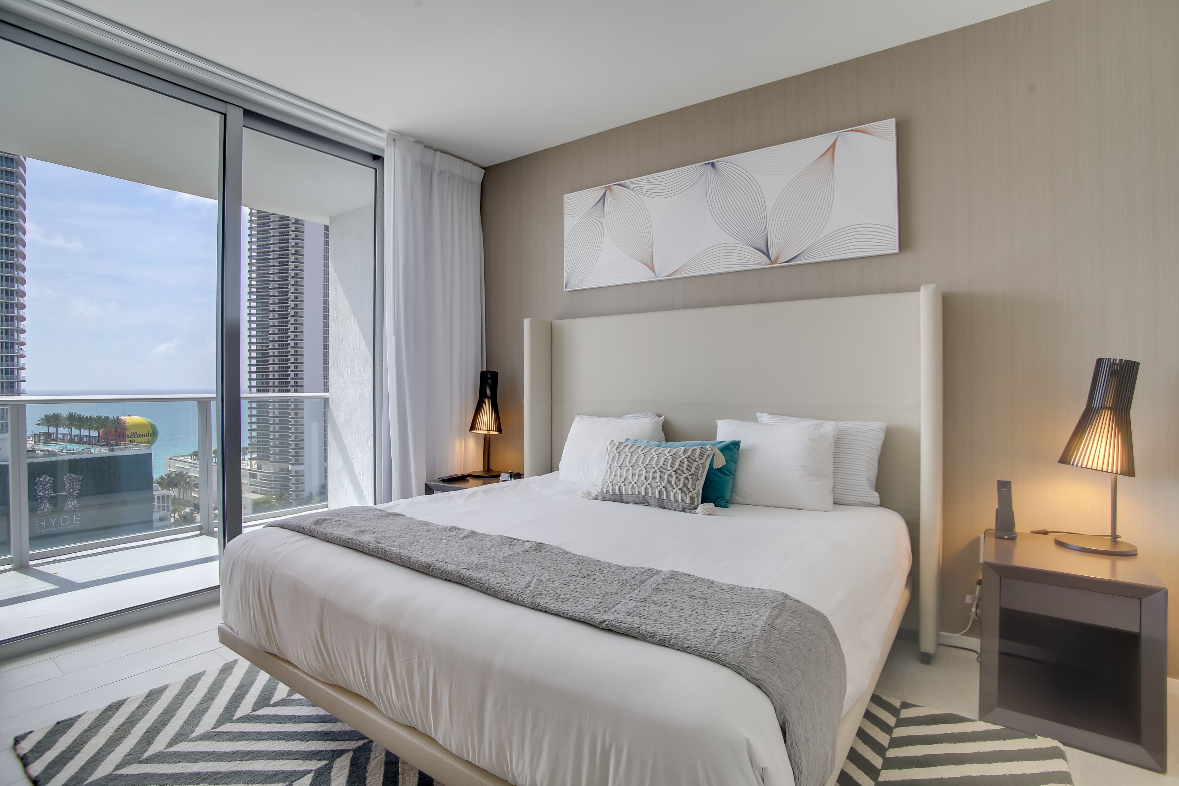 Bedroom 1 | California King Bed | Balcony Access | Laptop-Friendly Workspace