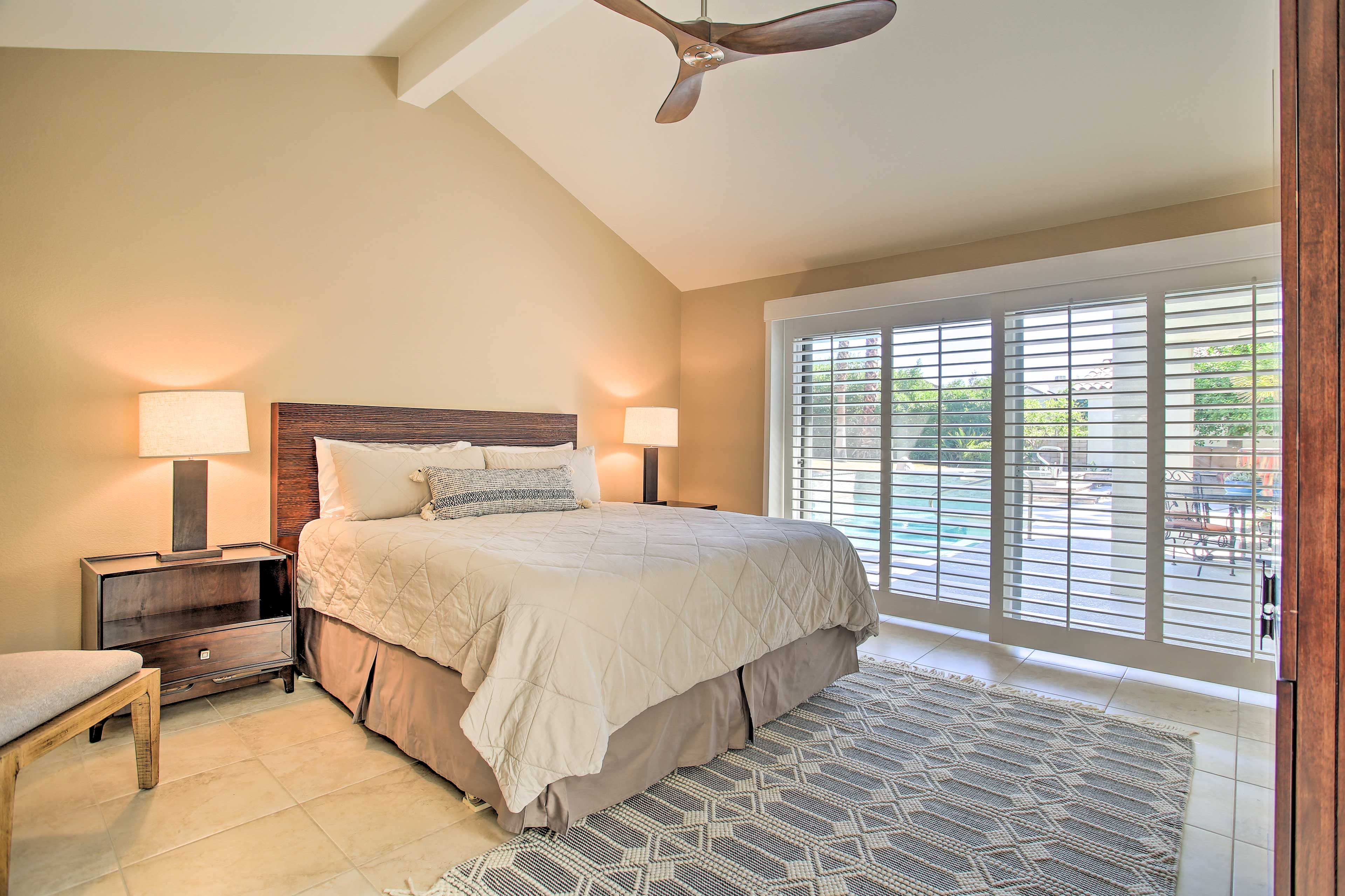 Bedroom 1 | California King Bed | Access to Patio/Pool Area