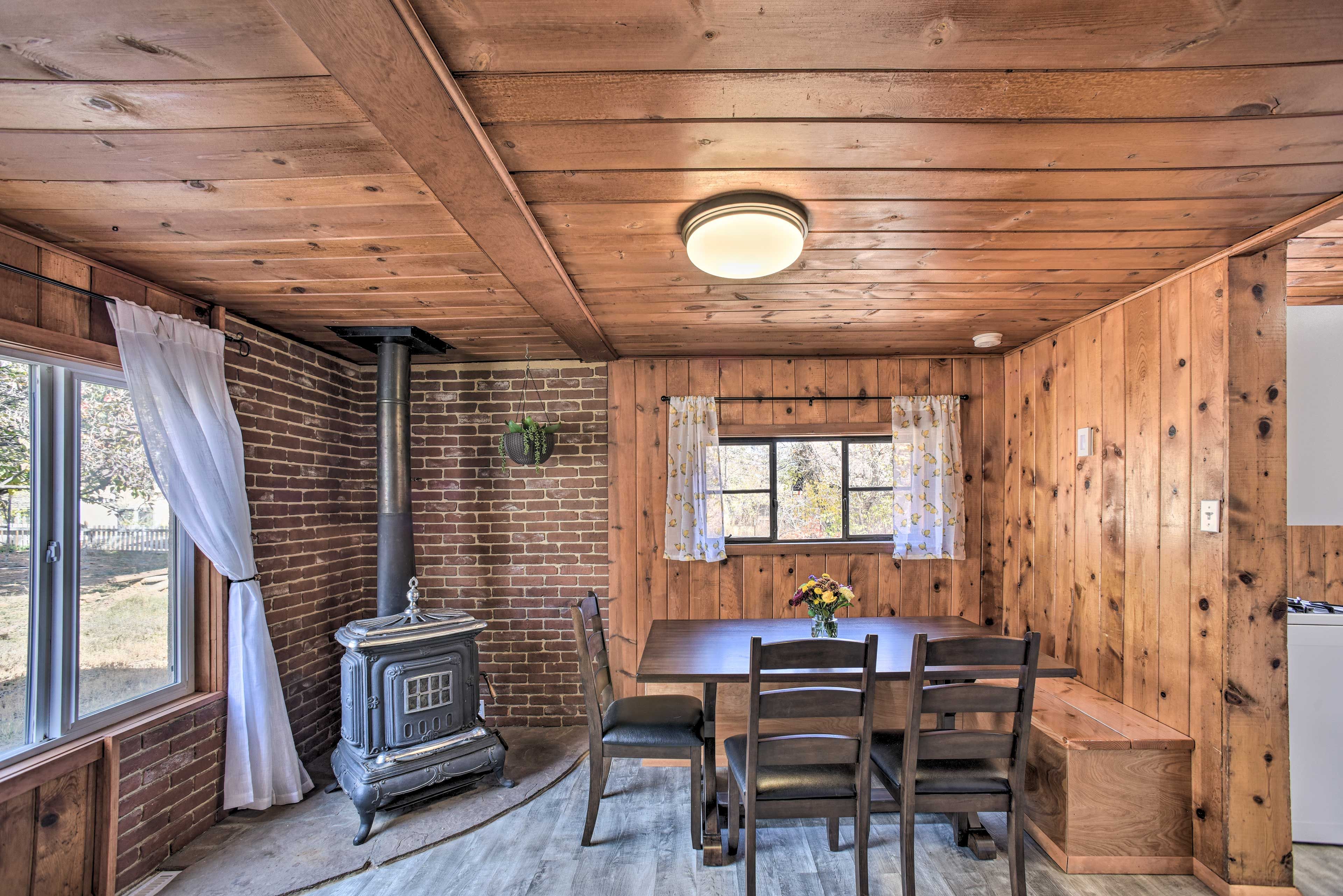 Dining Area | Decorative Wood-Burning Stove | Dishware Provided