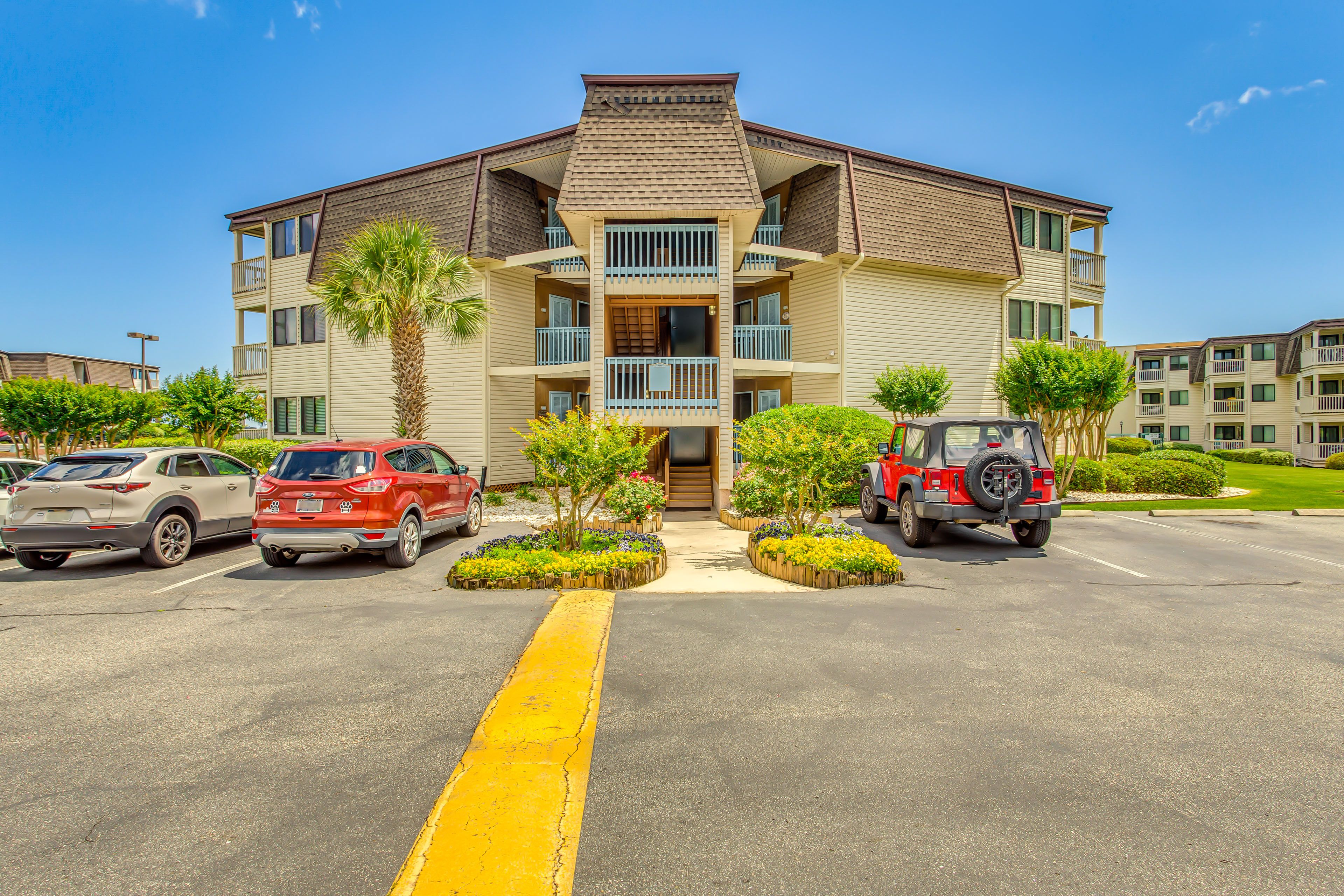 Building Exterior | Parking | Community Lot (2 Vehicles w/ Parking Pass)