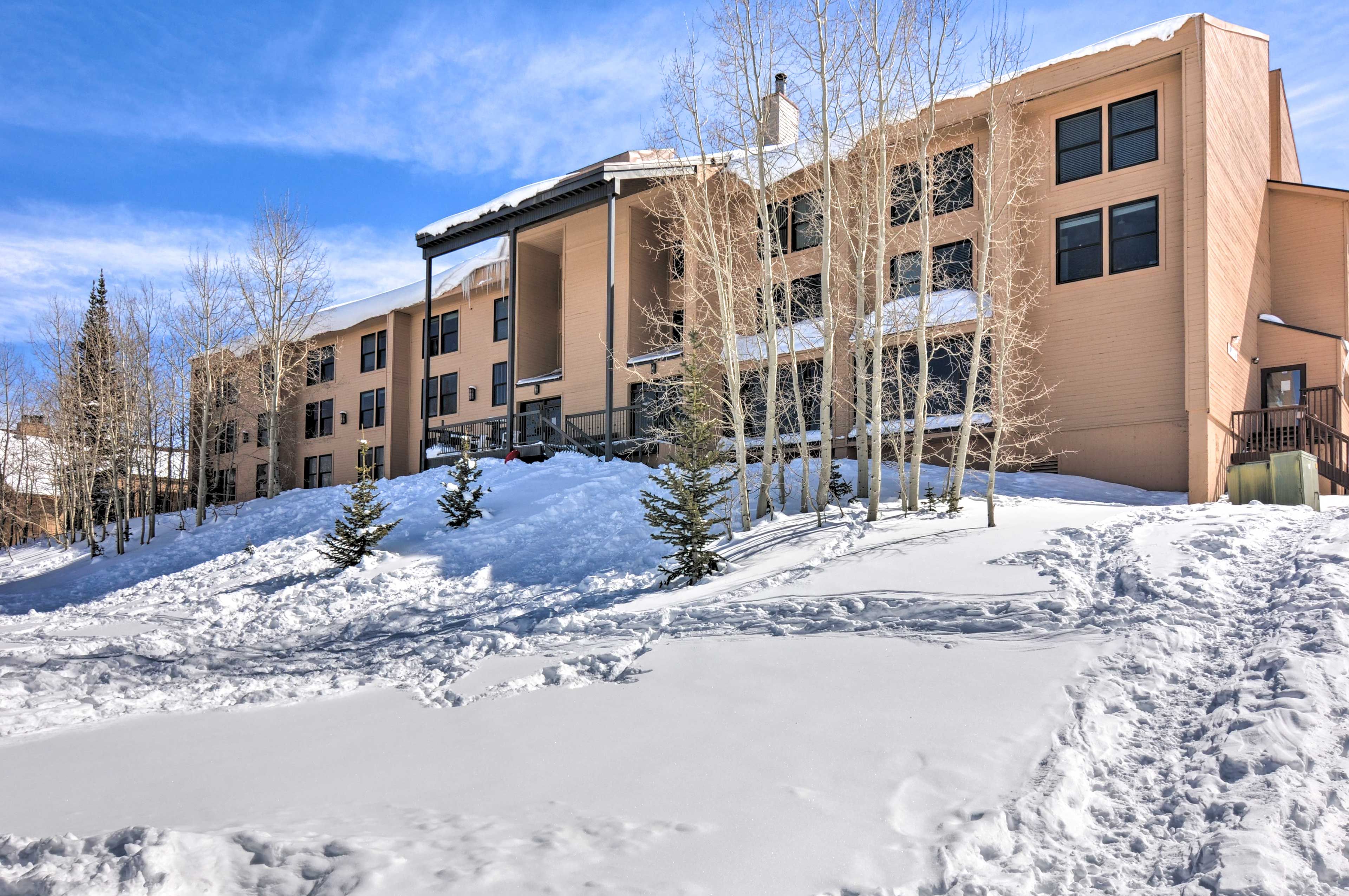 Complex Exterior | 1st-Floor Unit | Community Parking Garage (1 Designated Spot)