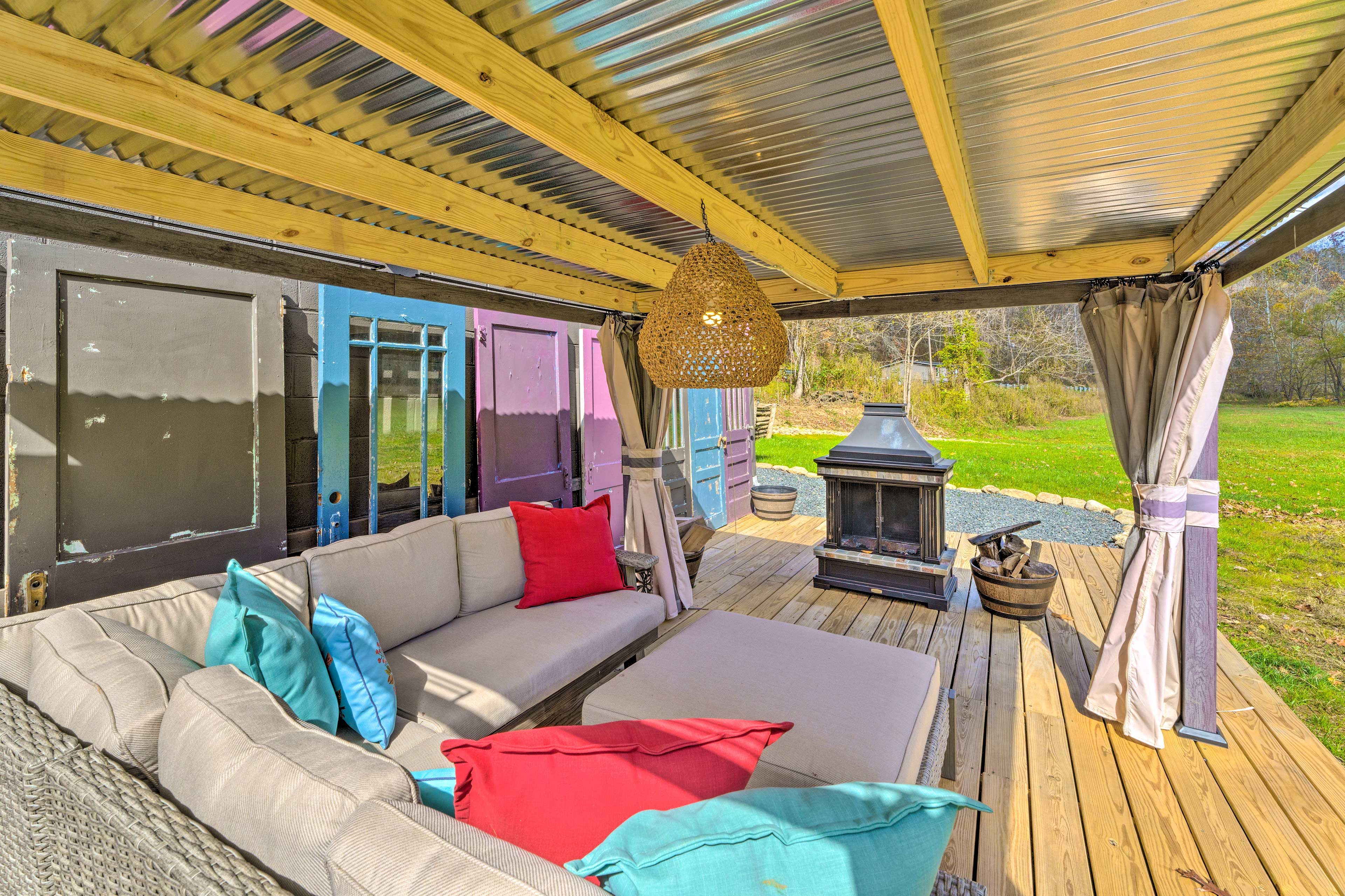 Cottage Exterior | Furnished Deck | Wood-Burning Fire Pit