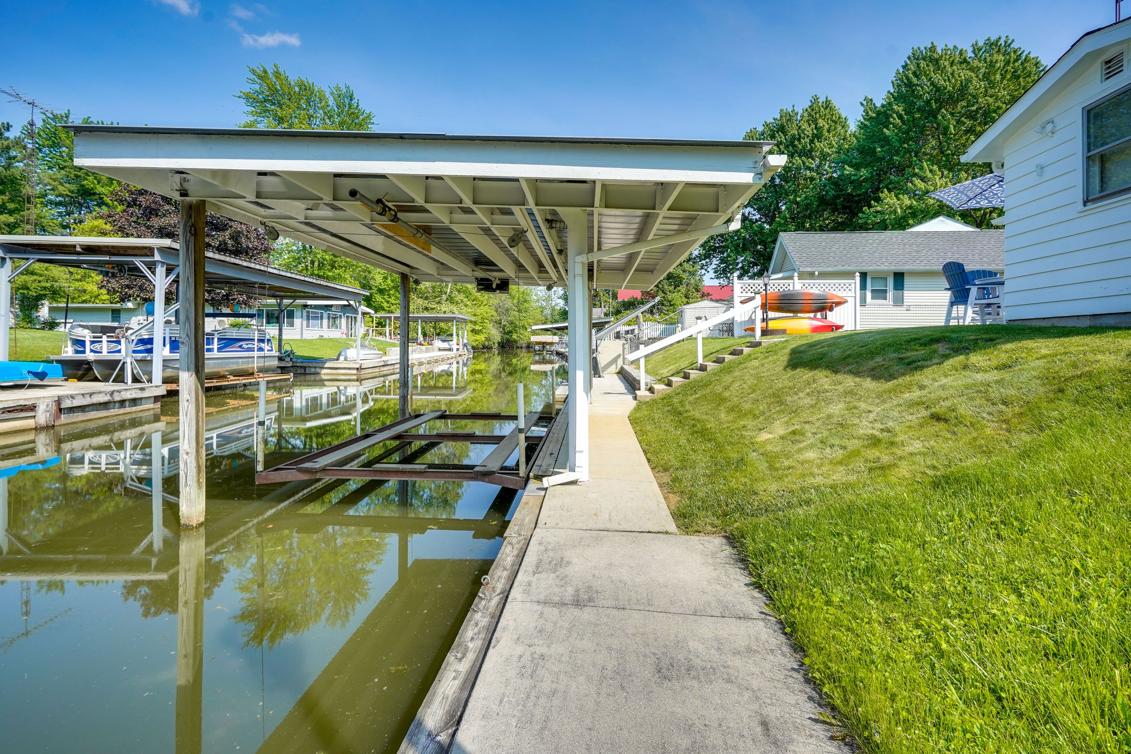 Cottage Exterior | Private Boat Dock w/ Lift | Jet Ski Lift | Channel Access