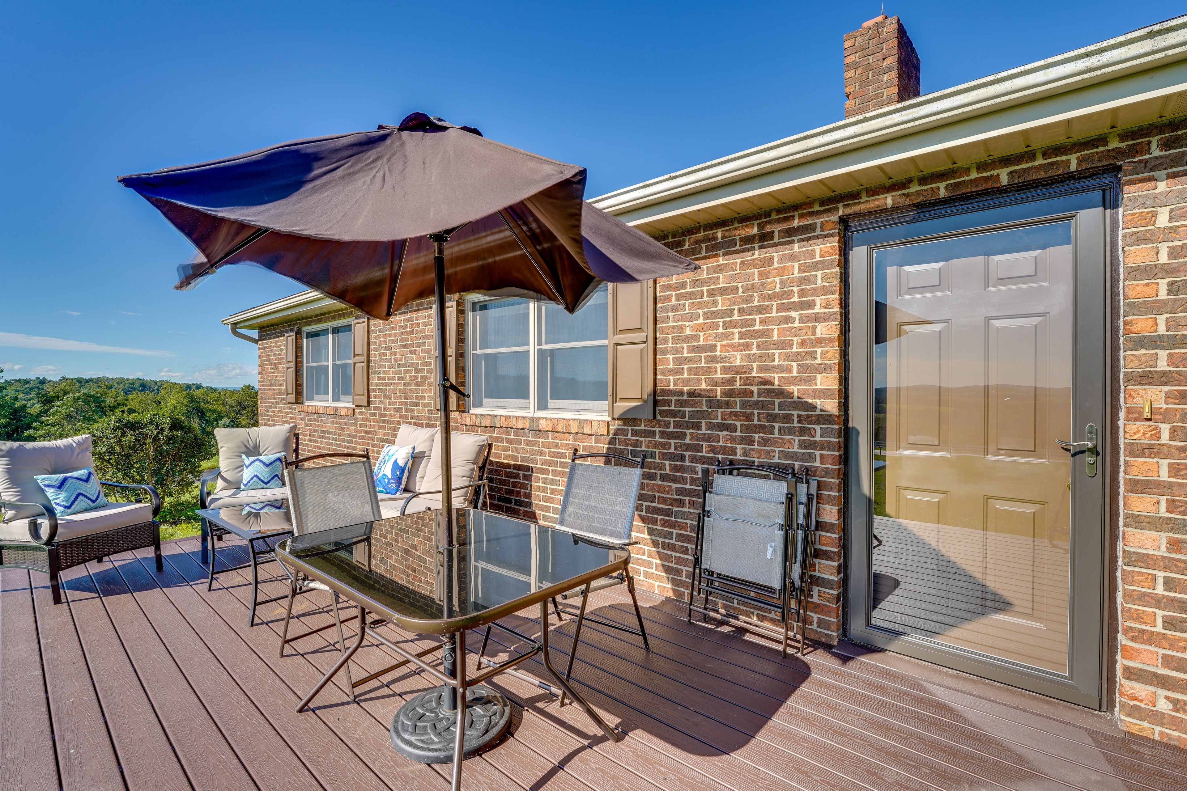 House Exterior | Furnished Deck | Dining Area | Hill Views
