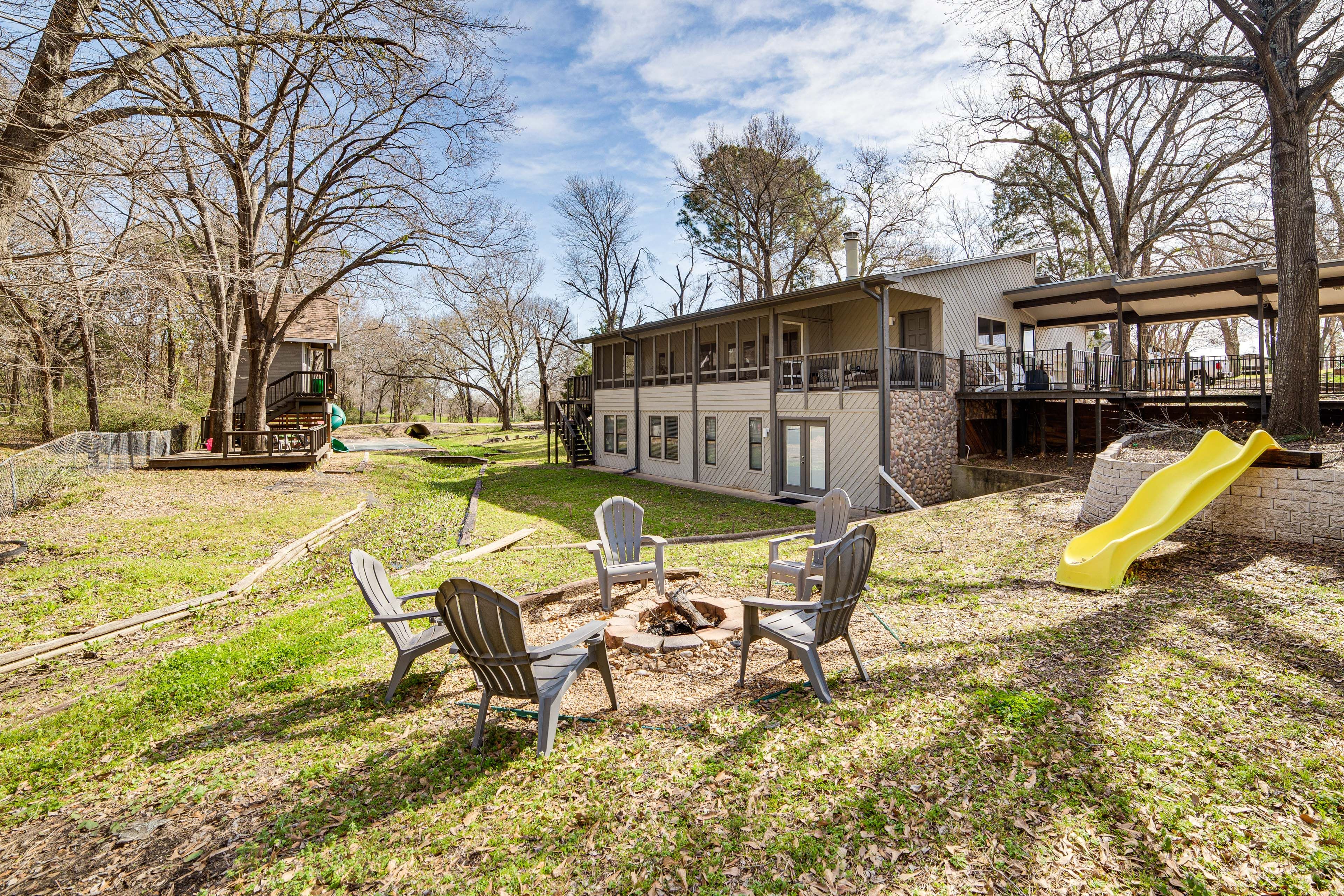 Back Exterior | Gas & Wood-Burning Fire Pits | Spacious Yard | Kids' Playset