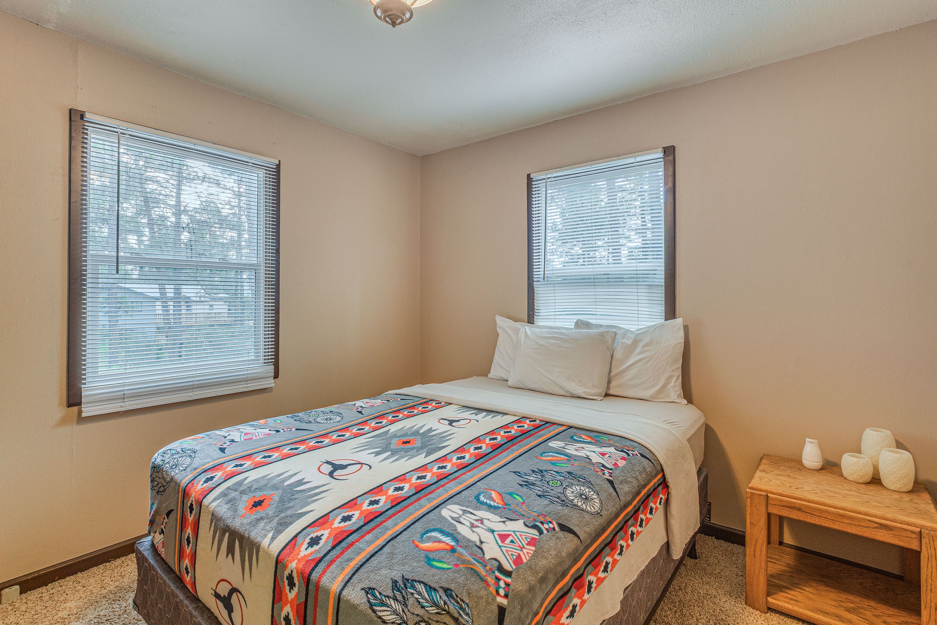 Bedroom 1 | Main Level | Queen Bed | Flat-Screen TV | 2 Chairs | Linens Provided