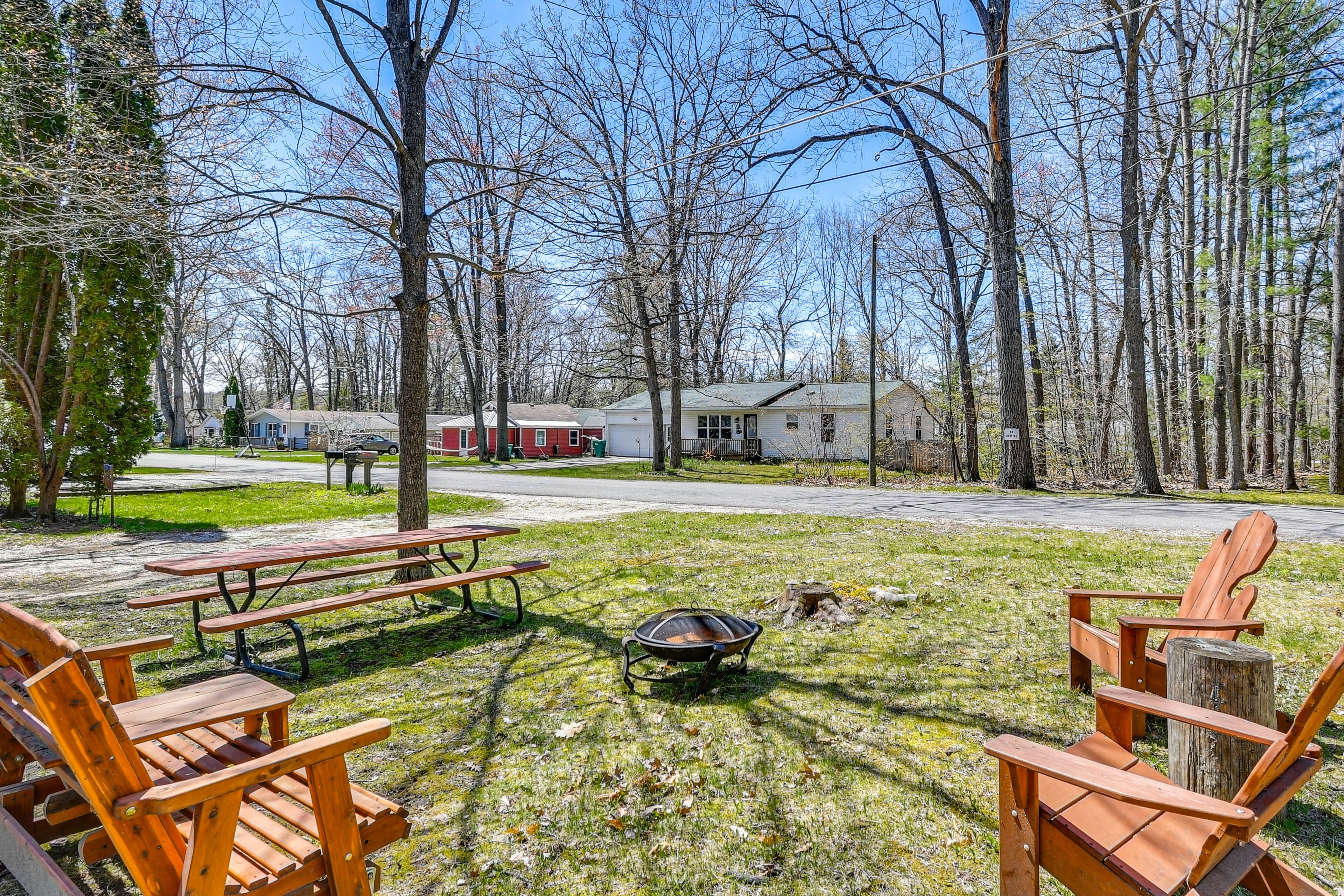Prudenville Vacation Rental | 2BR | 1BA Exterior | Fire Pit w/ Seating | Hammock