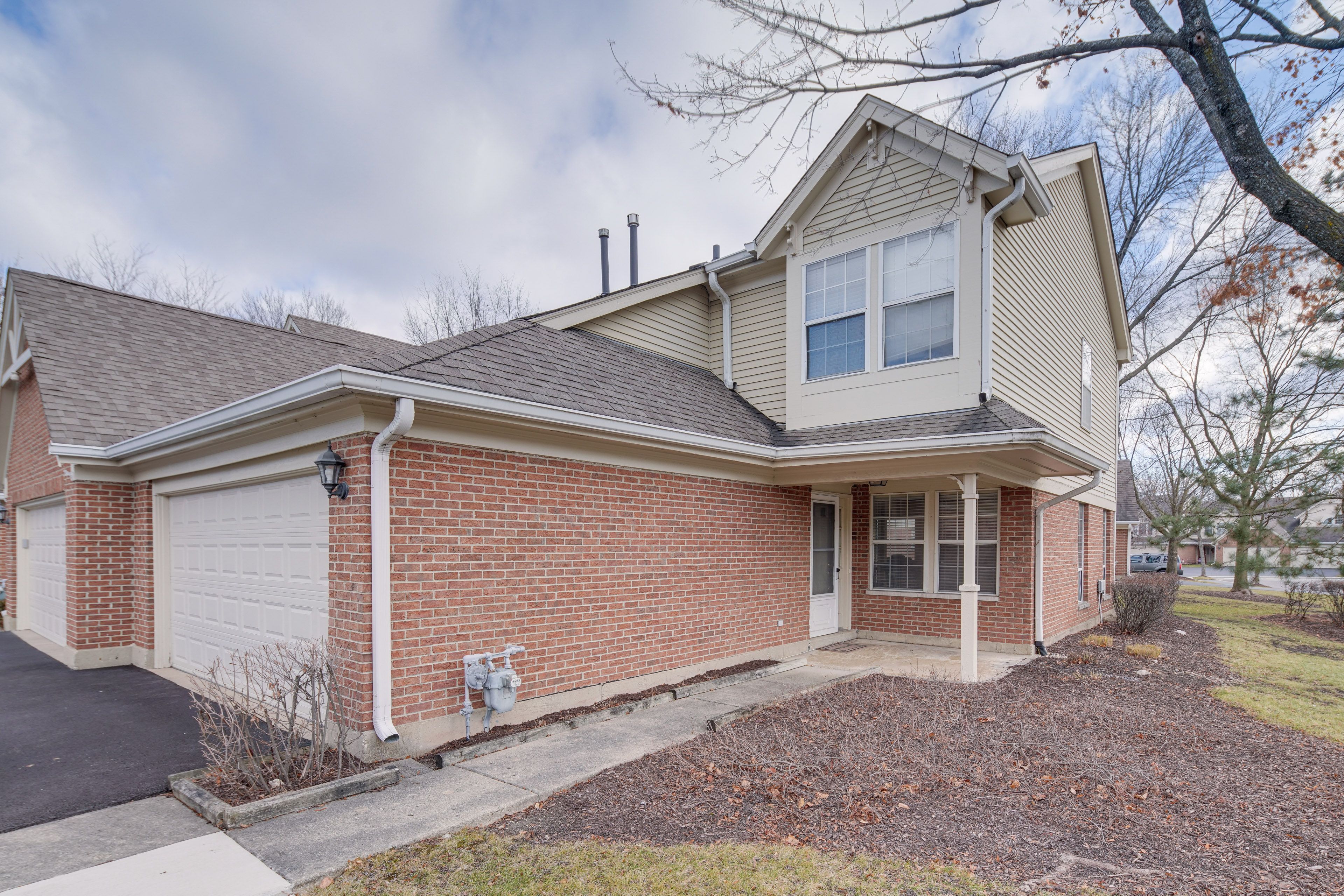 Townhome Exterior | Garage Parking | Charcoal Grill