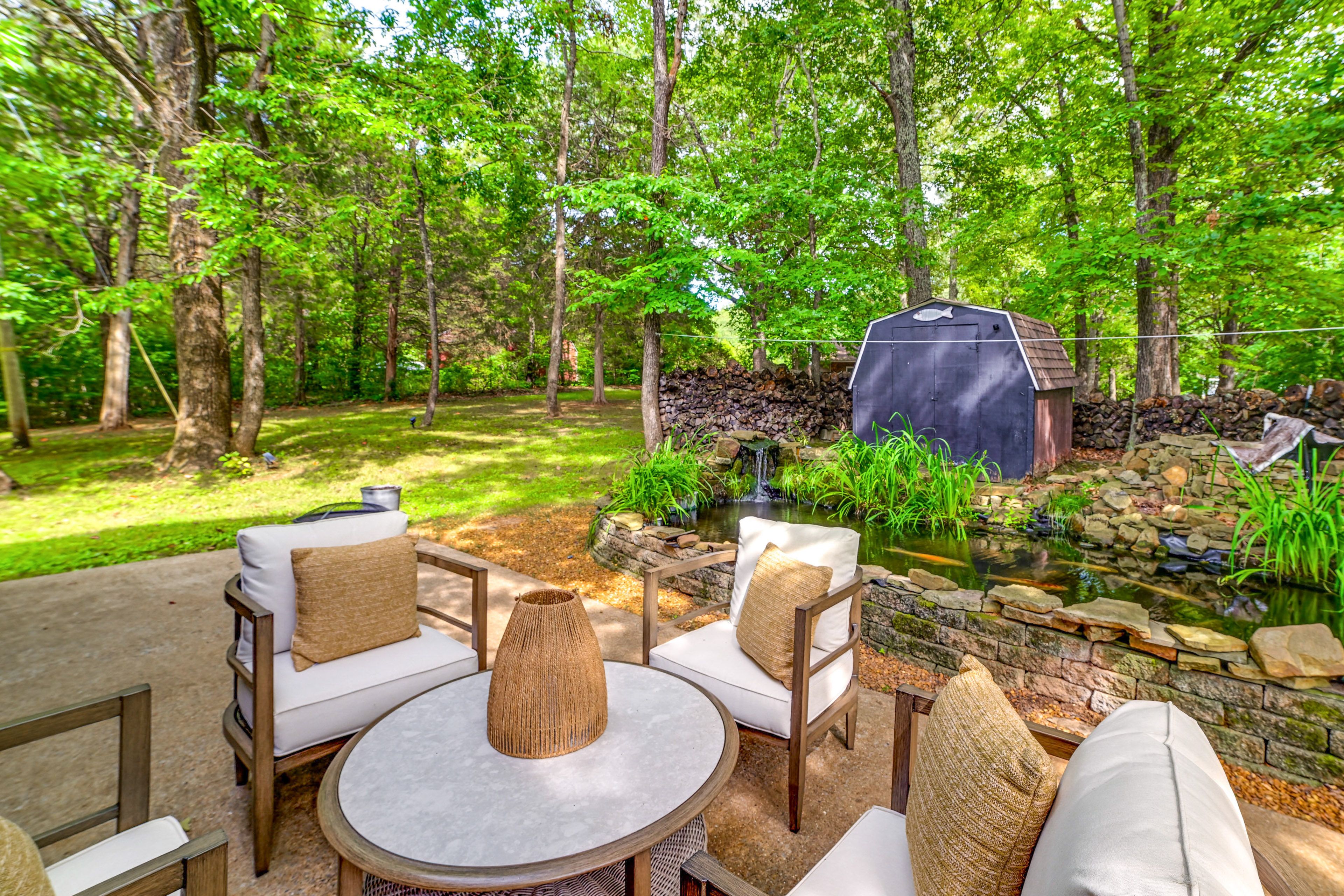 Cabin Exterior | Furnished Patio | Fish Pond w/ Waterfall