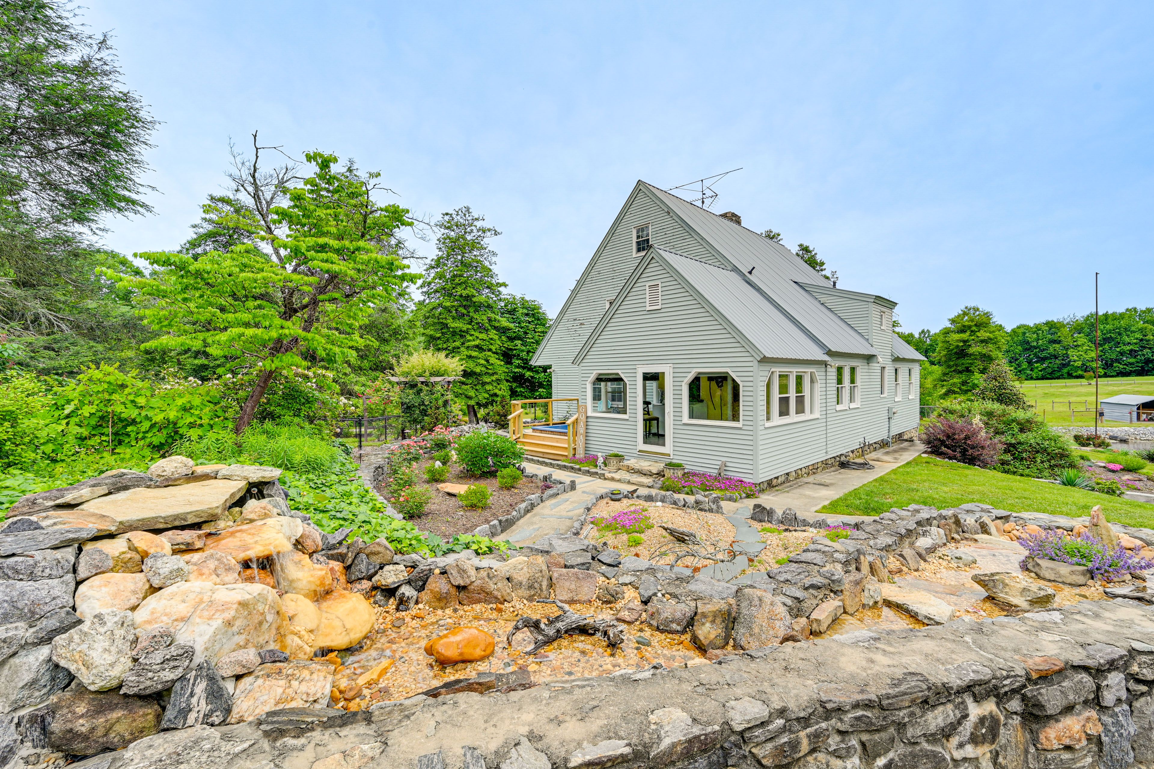 Exterior | Landscaped Yard w/ Waterfall | 2-Story Home
