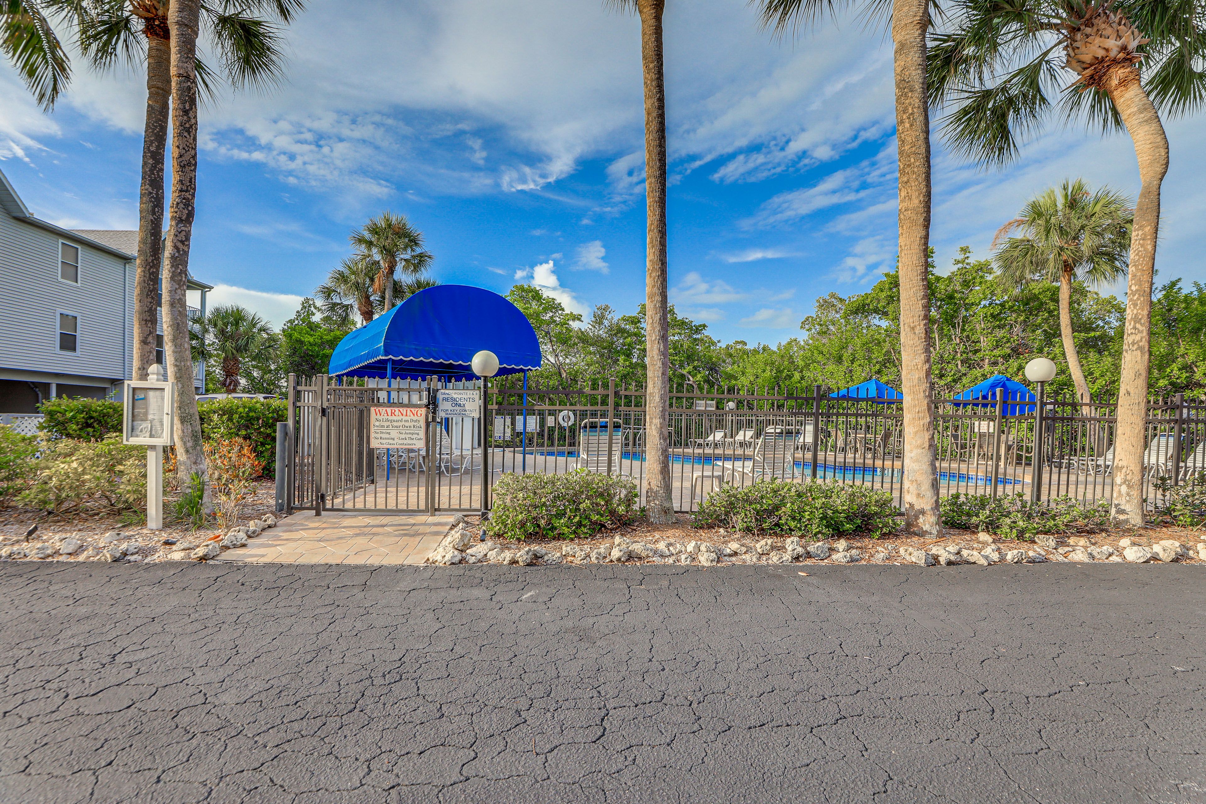 Sandy Pointe Community Amenities | Fenced-In Outdoor Pool | Lounge Chairs