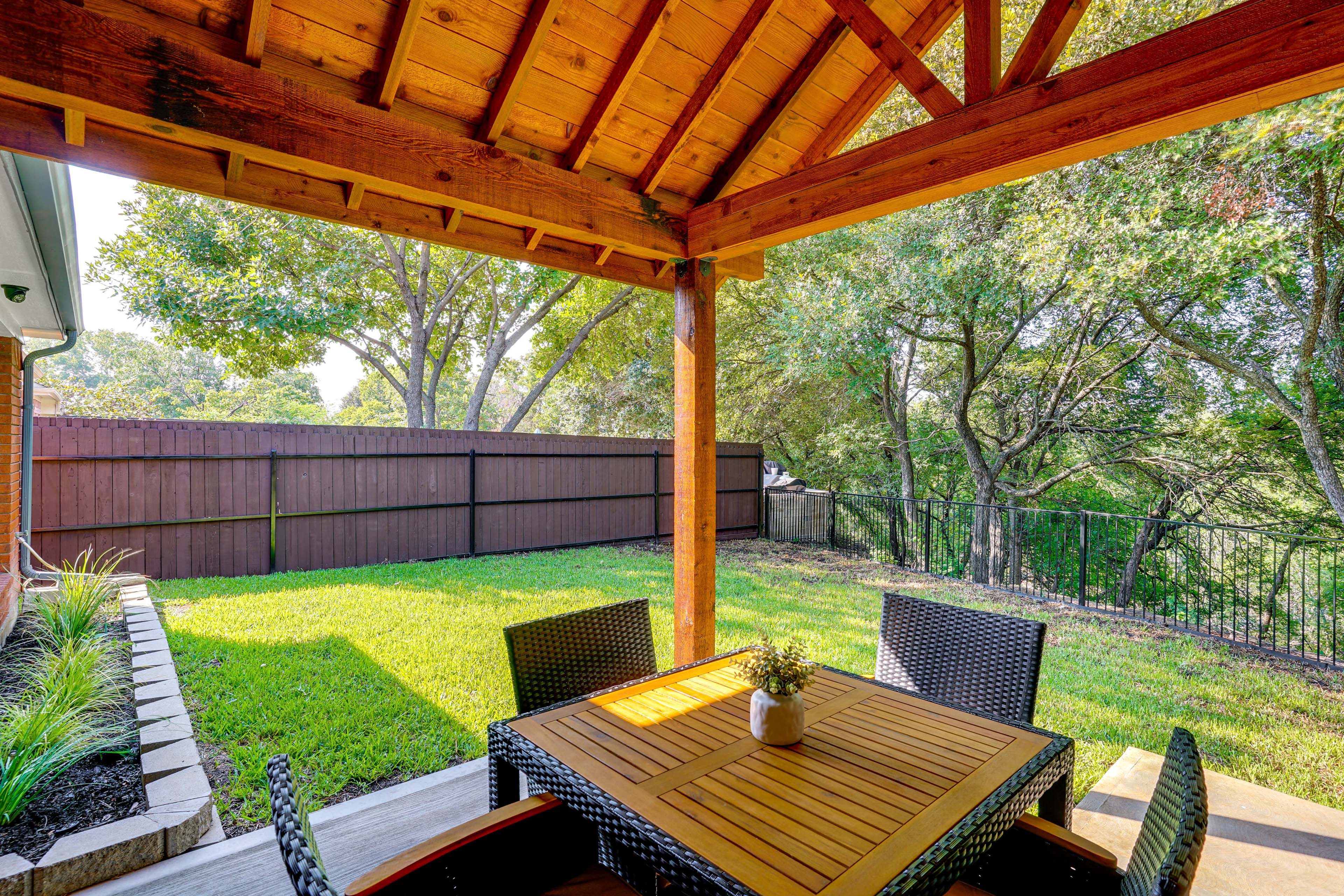 Covered Patio | Fenced-In Backyard | Creek Views