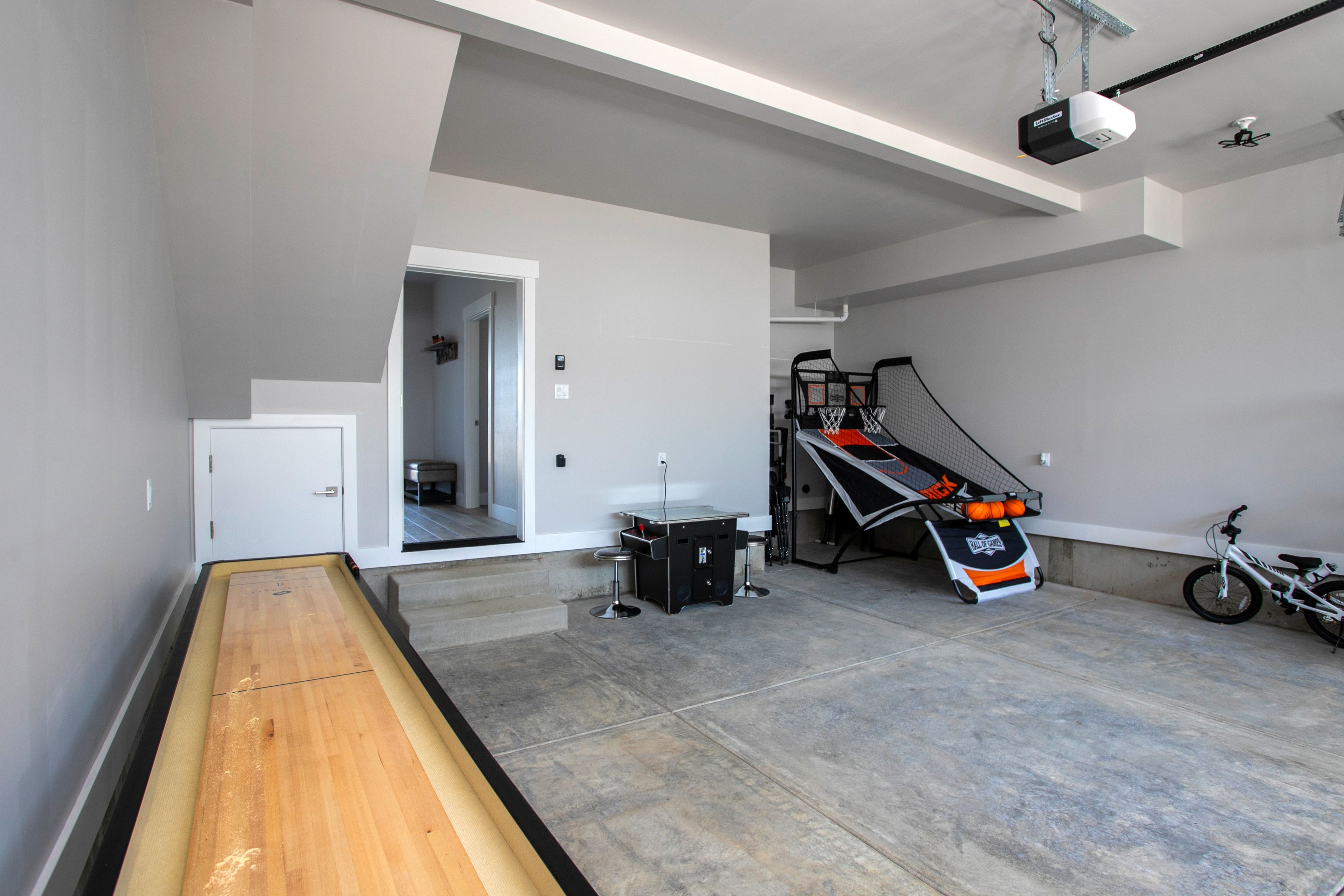 Garage Game Room | 1st Floor | Shuffleboard Table | Arcade Table