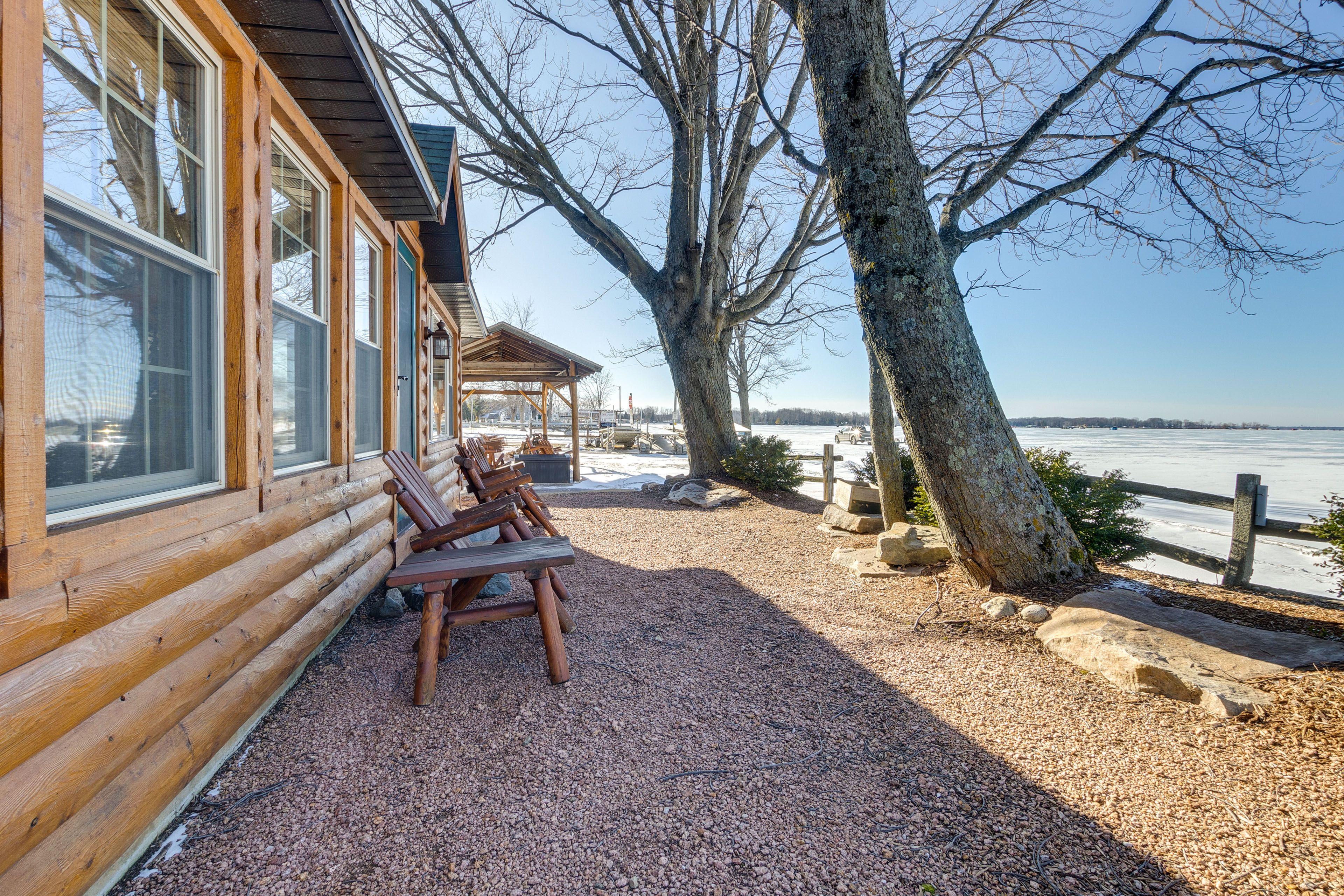 Cabin Exterior | Shared Gravel Area w/ Seating | Lake Views & Access